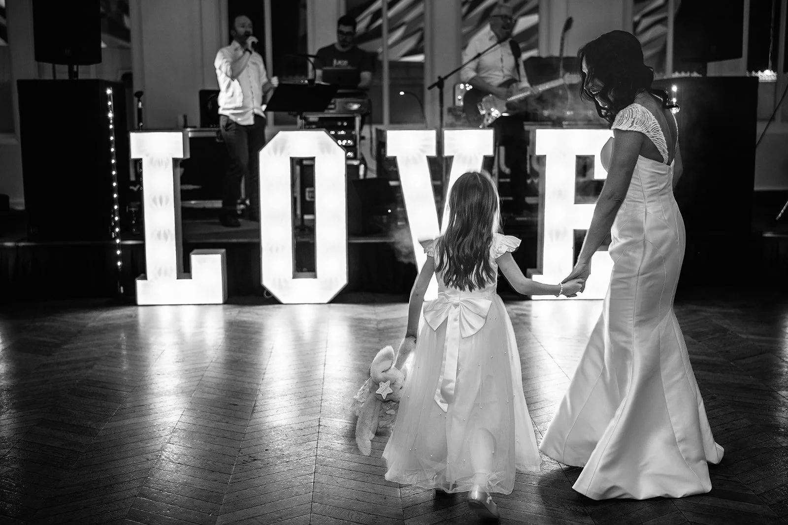 The bride and her daughter hold hands on the dance floor at The Titanic Hotel, Belfast.