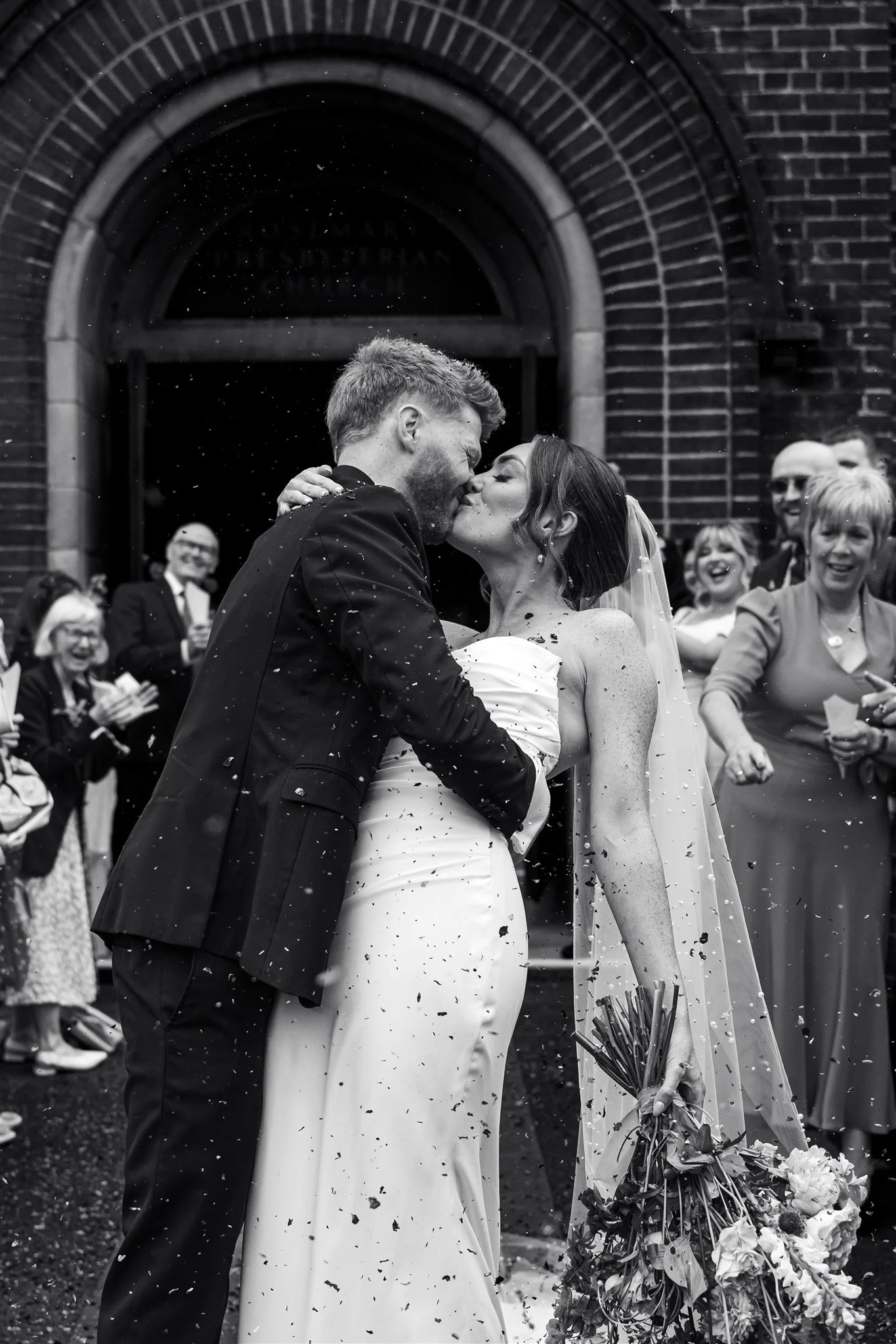 Black and white wedding photograph taken outside Belfast City Hall by a Belfast wedding photographer