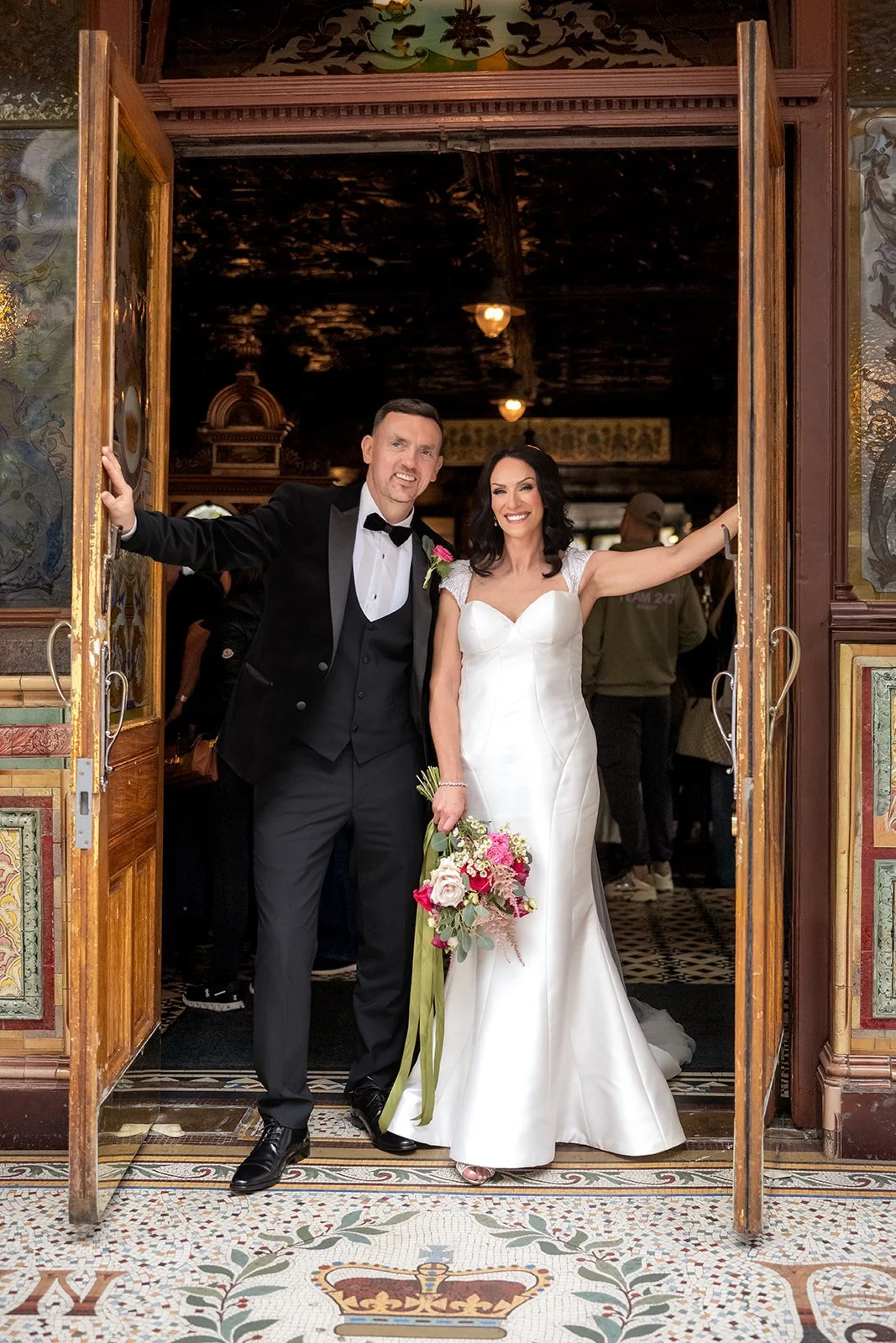 Wedding photo taken at the entrance to The Crown Bar, Belfast