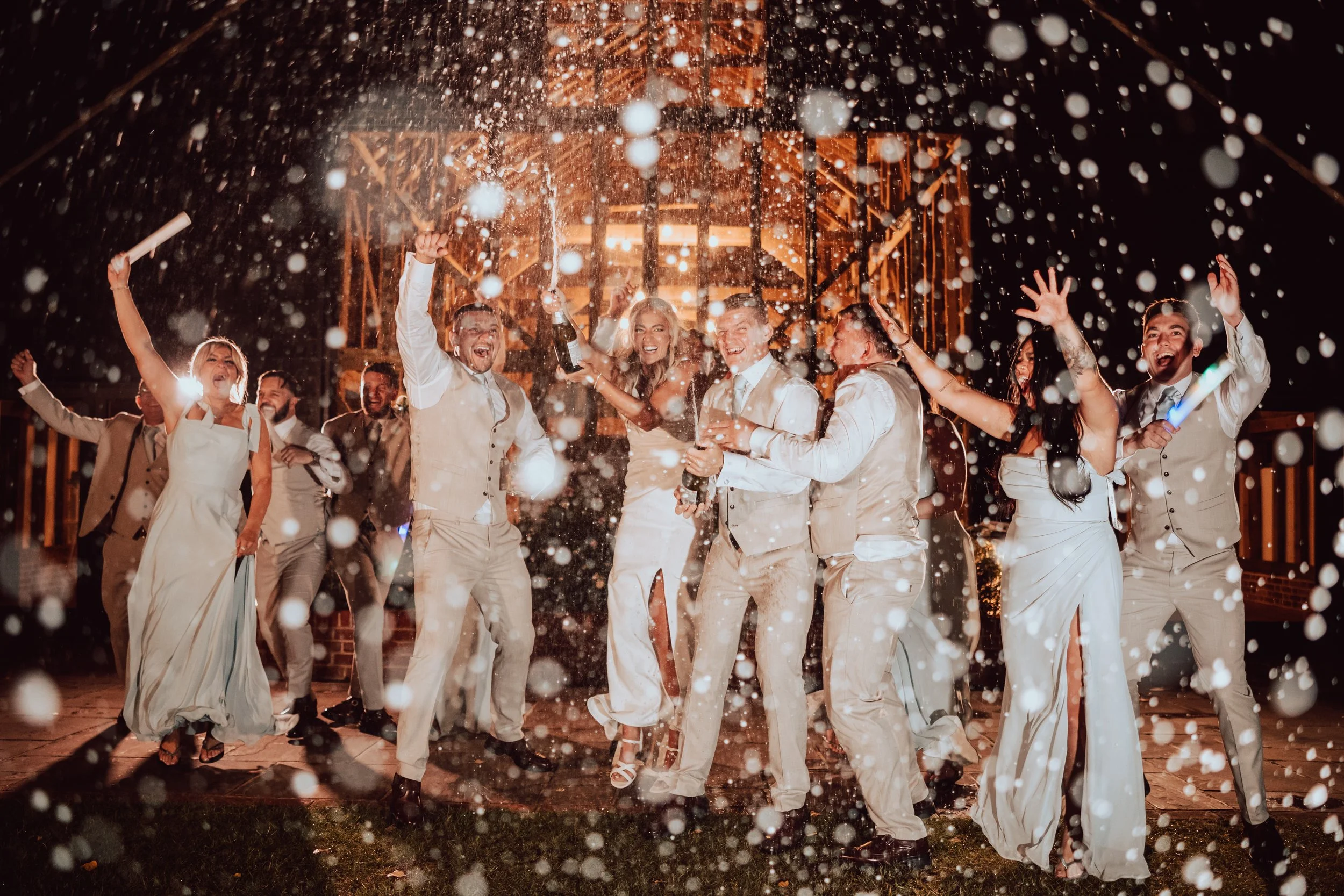 Wedding Day Champagne Spray captured by Wedding Photographer Liam Gillan at Blake Hall 