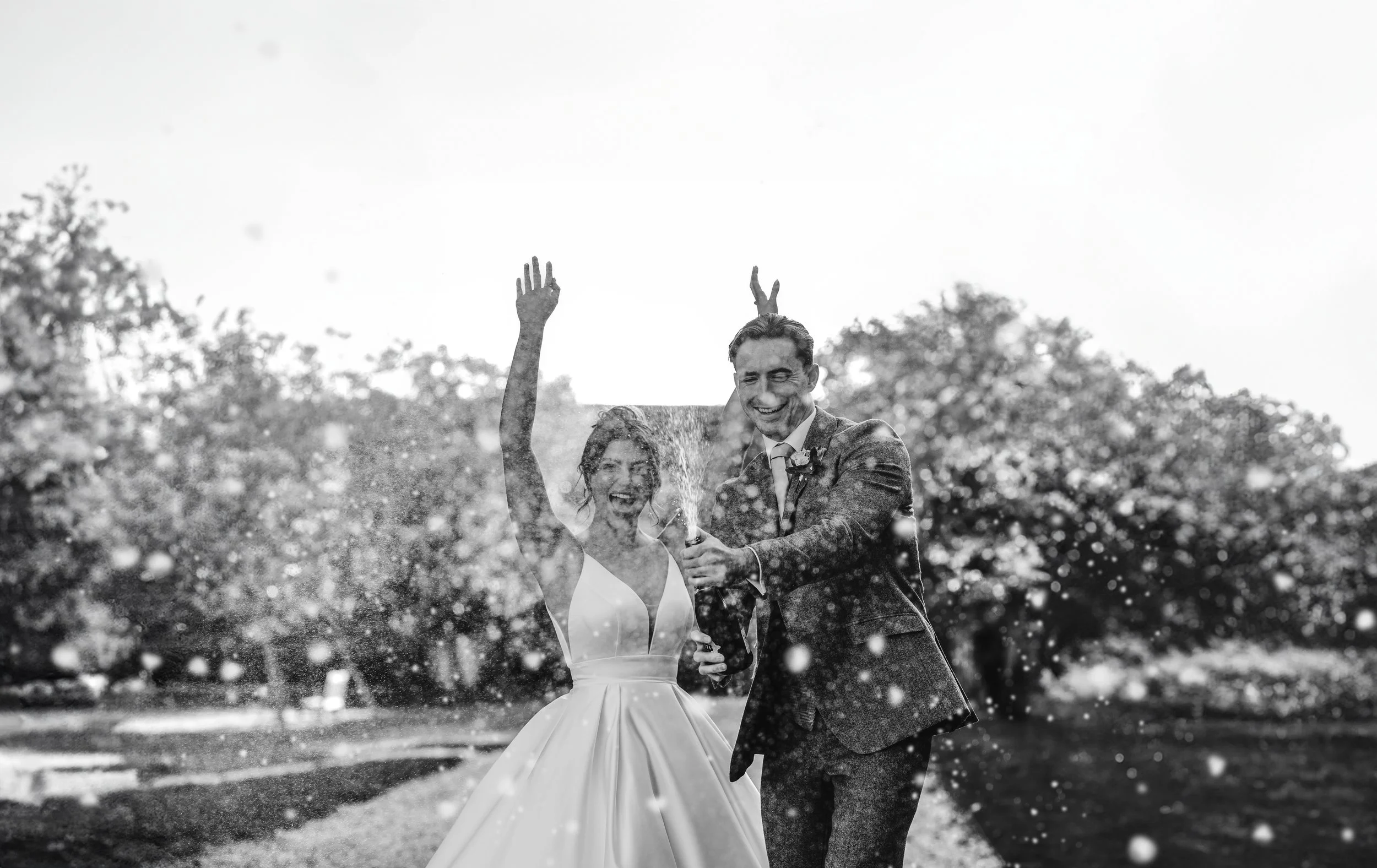 Couple spraying champagne at St Osyths Priory Wedding Photography