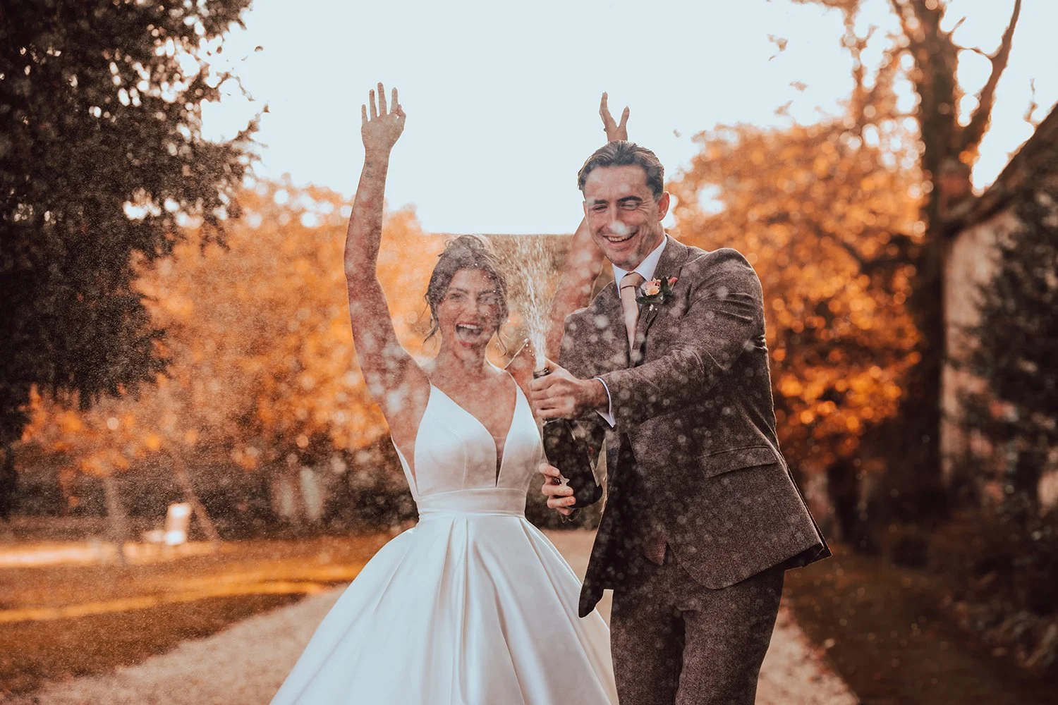 Wedding Day Champagne Spray captured by Wedding Photographer Liam Gillan at St Oysths