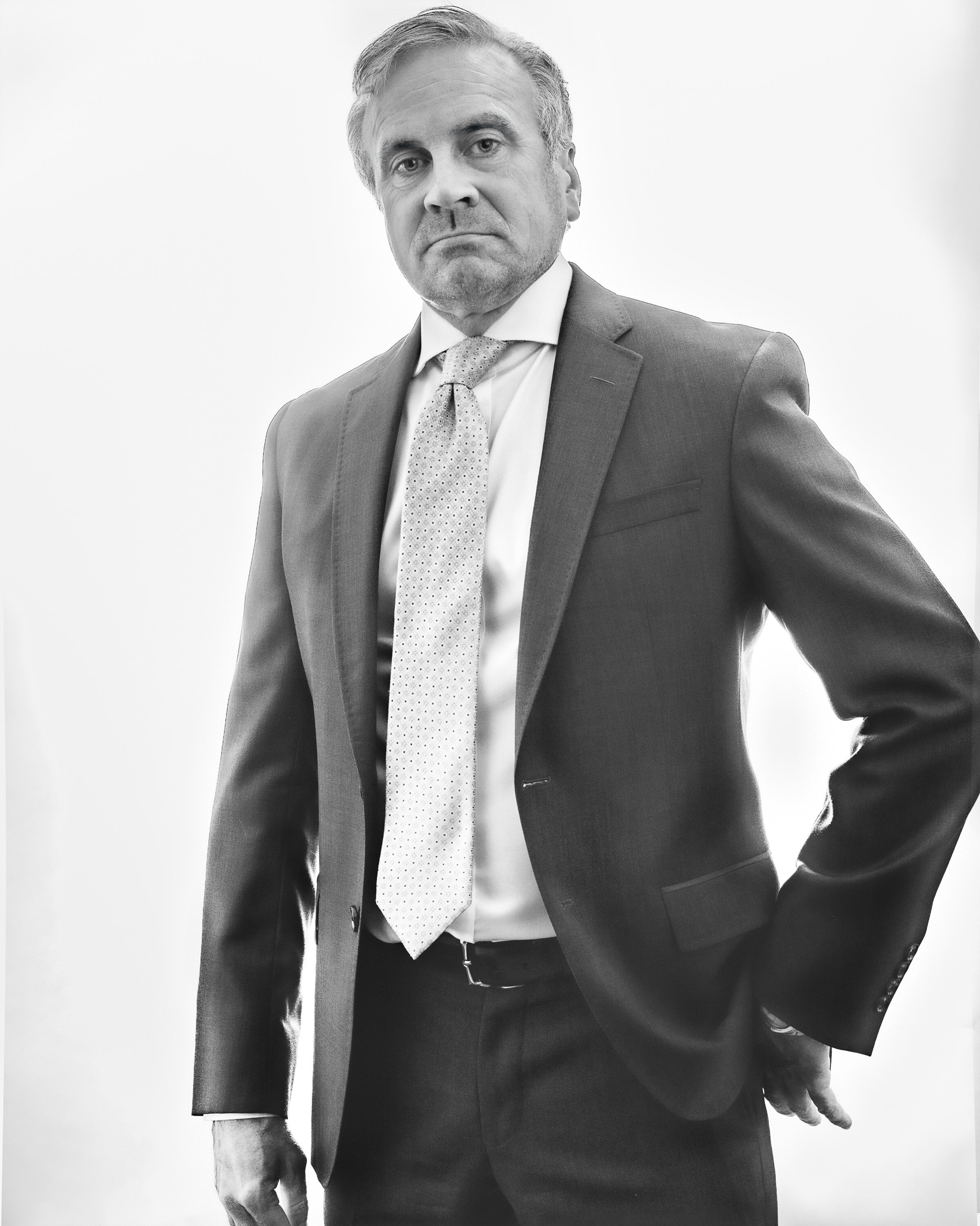 Black and white portrait of a man in a suit and tie.