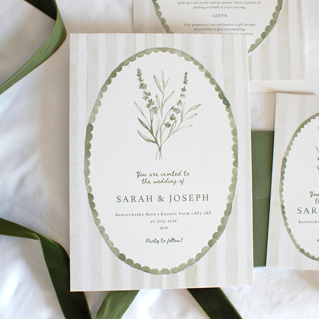 Wedding stationery set including a save the date card, RSVP card, detailed schedule, and an envelope with eucalyptus leaves in the background.