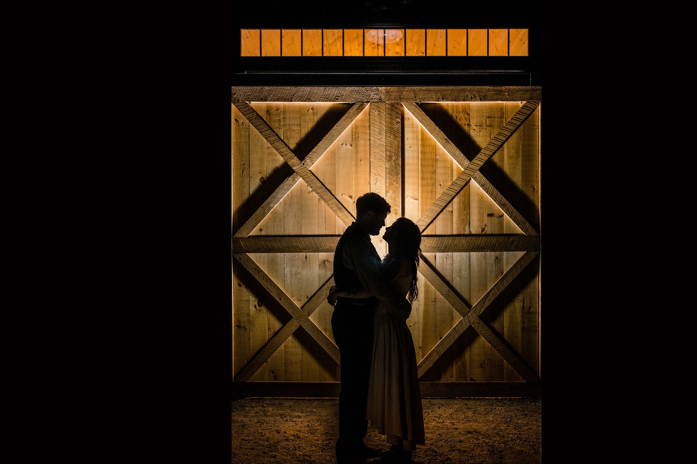 Dramatic image of bride and groom near the wedding barn shot by Robert Ortiz Photography (Copy)