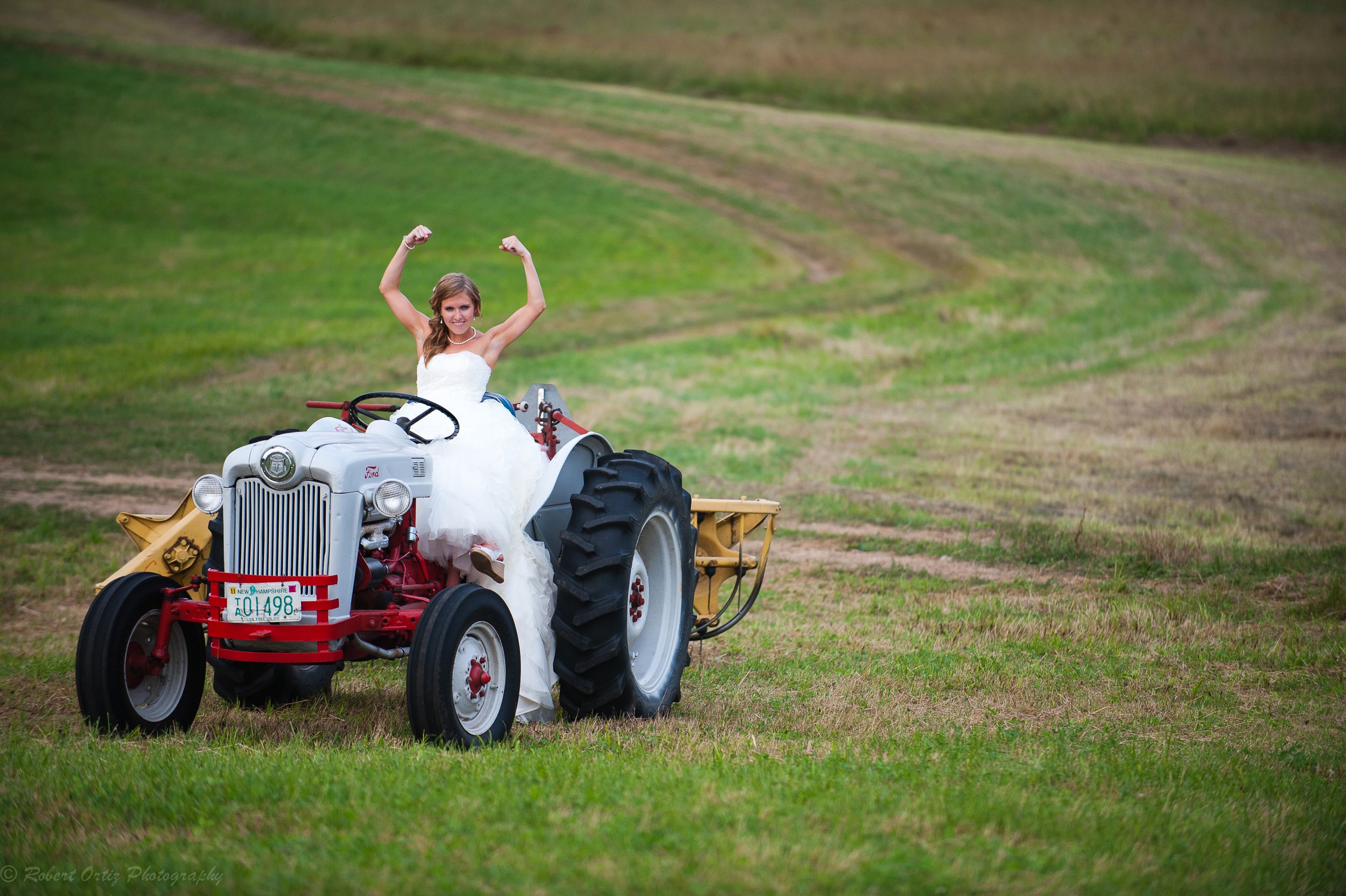 Bride on Tractor at Whitney's Inn by Robert Ortiz Photography (Copy)