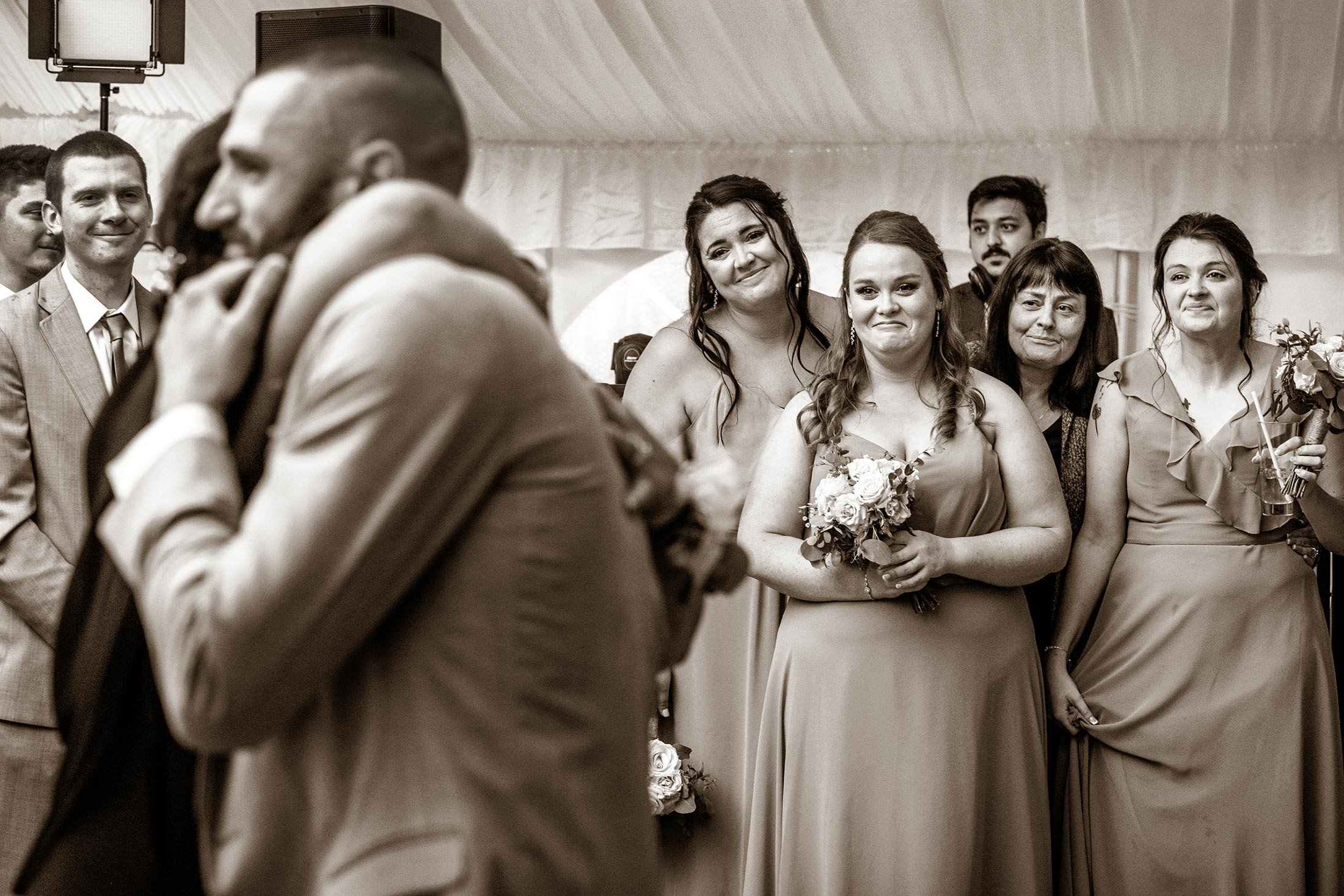 Black and white photo of wedding guests emotional looks at groom and mom | Robert Ortiz Photography (Copy)
