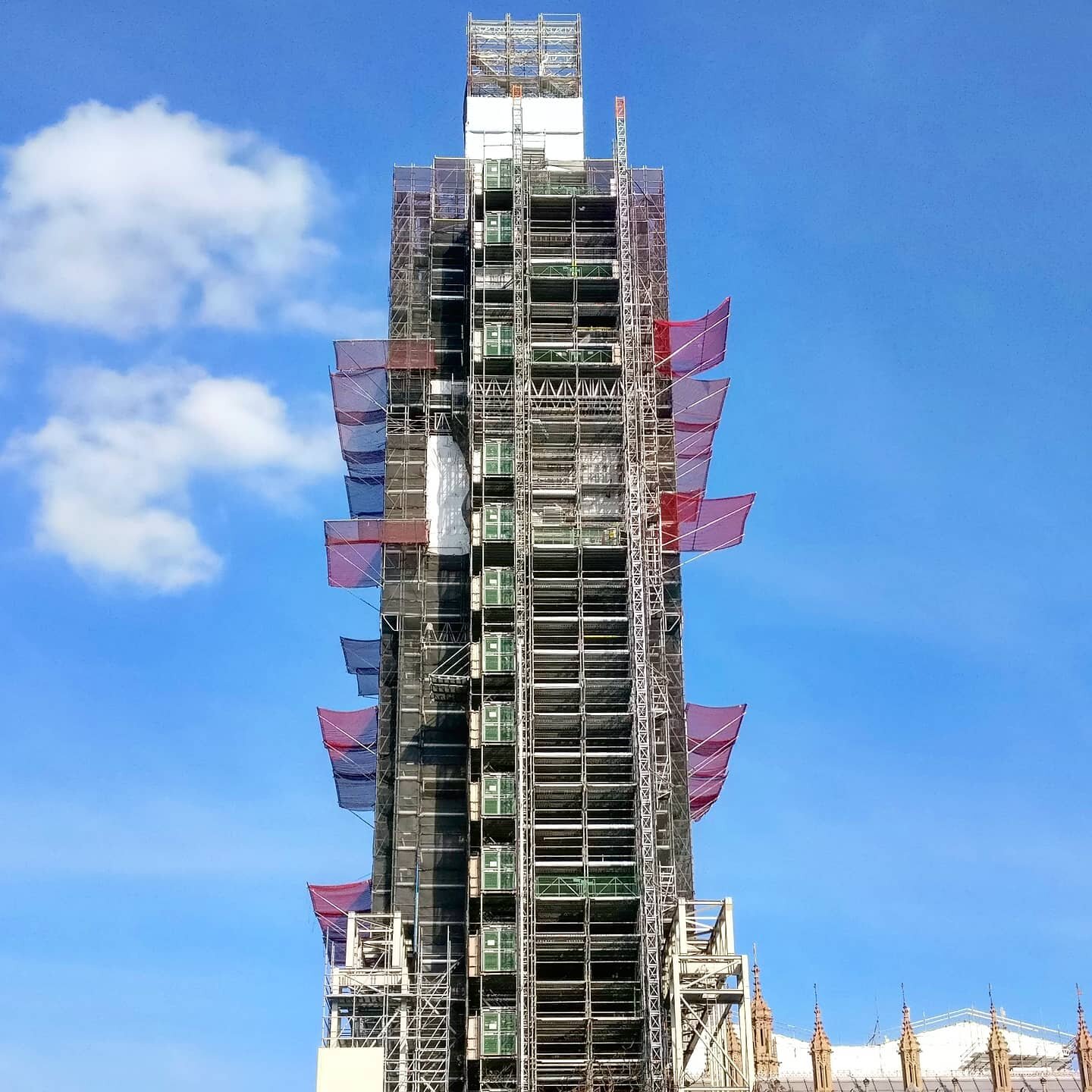 Big Ben. Yes, this is the clocktower Big Ben in London, England. During a visit in 2019, the tower was under a restorative maintenance program. This required the construction of scaffolding that wrapped around the tower for its fill height. The tower