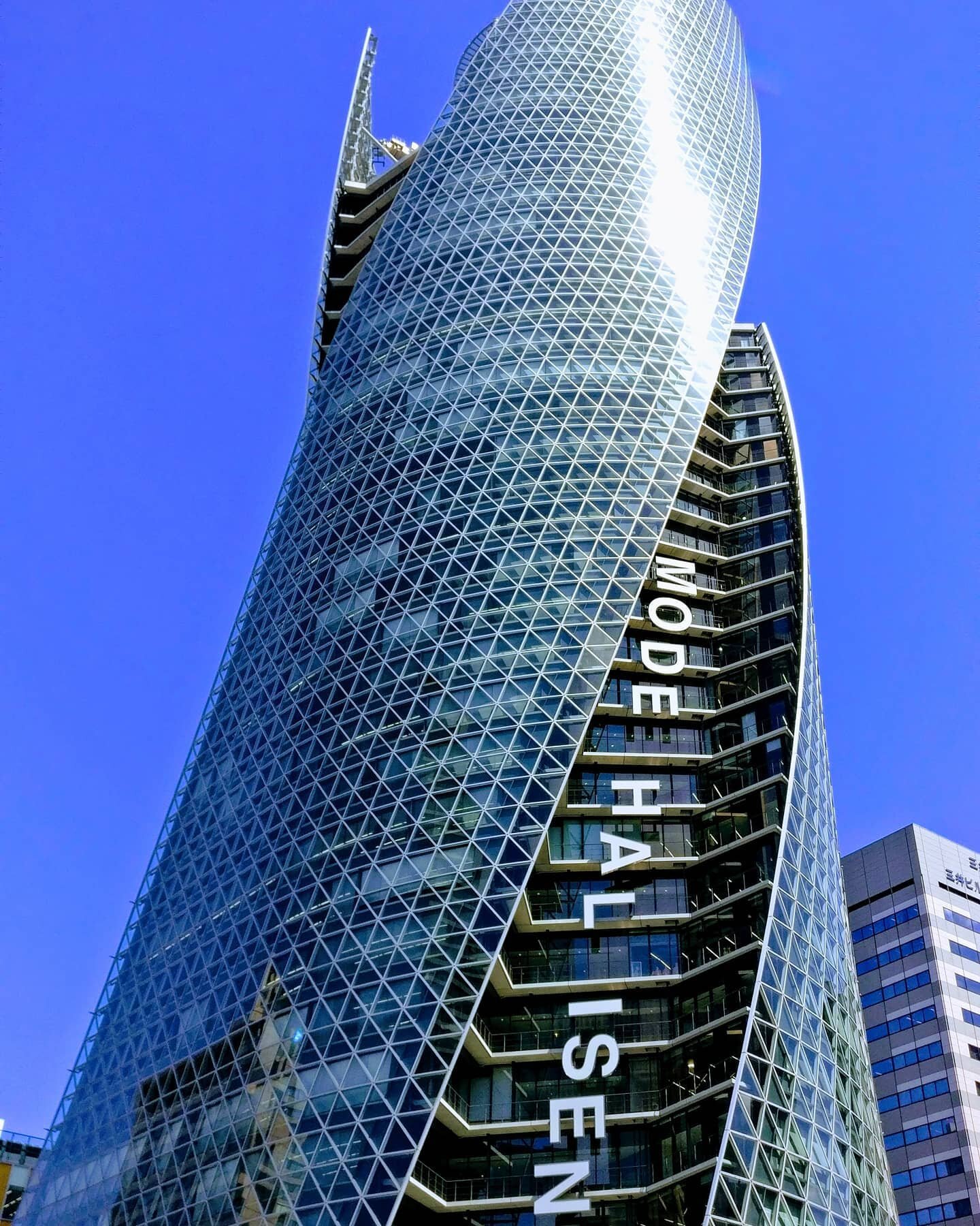 The Mode Hal Isen tower in Nagoya Japan is an educational facility with three schools. The building was designed by Nikken Sekkei and constructed by Obayashi Corporation. The curvy tower greets visitors walking out of the main train station. The use 