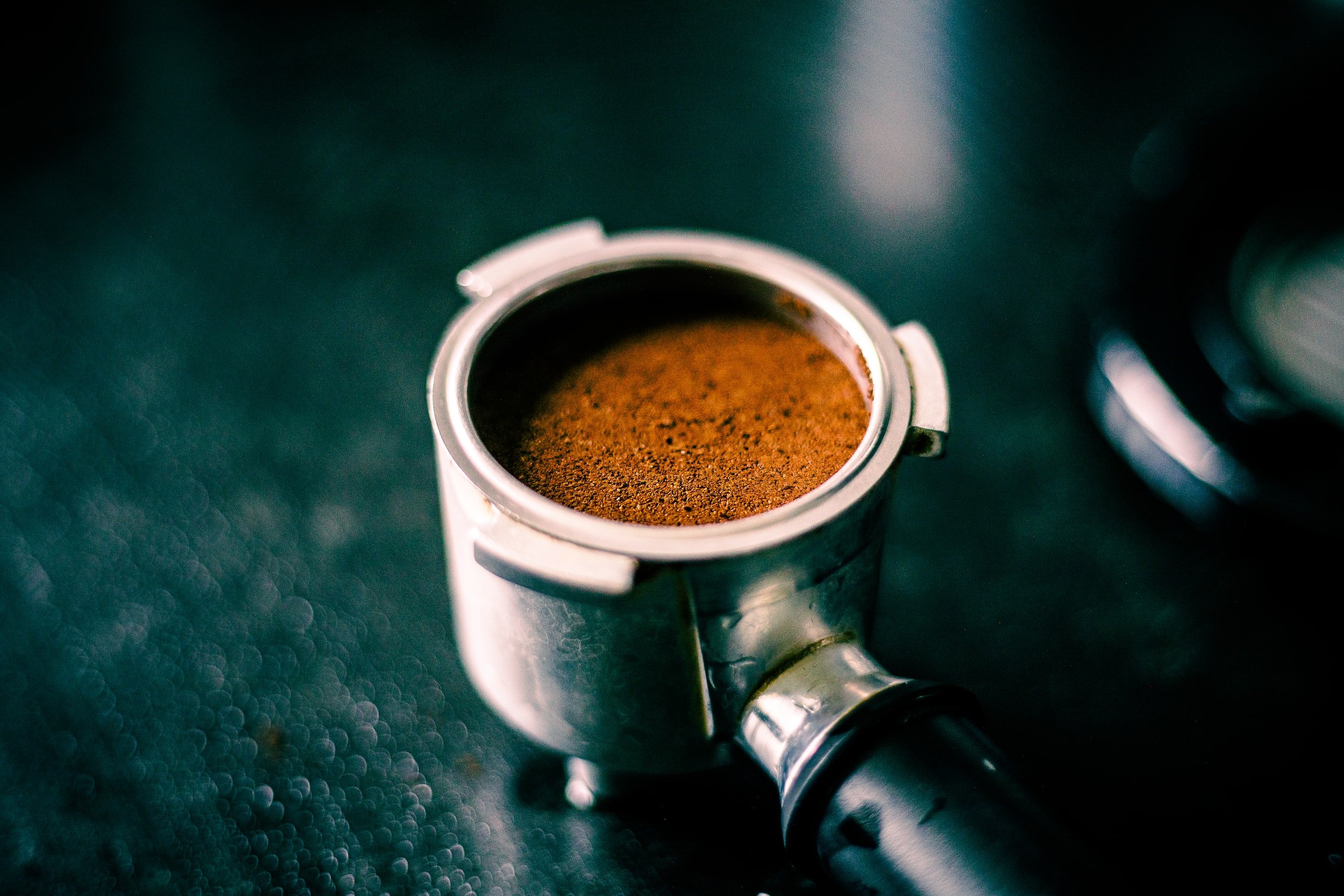 espresso portafilter with tamped grounds