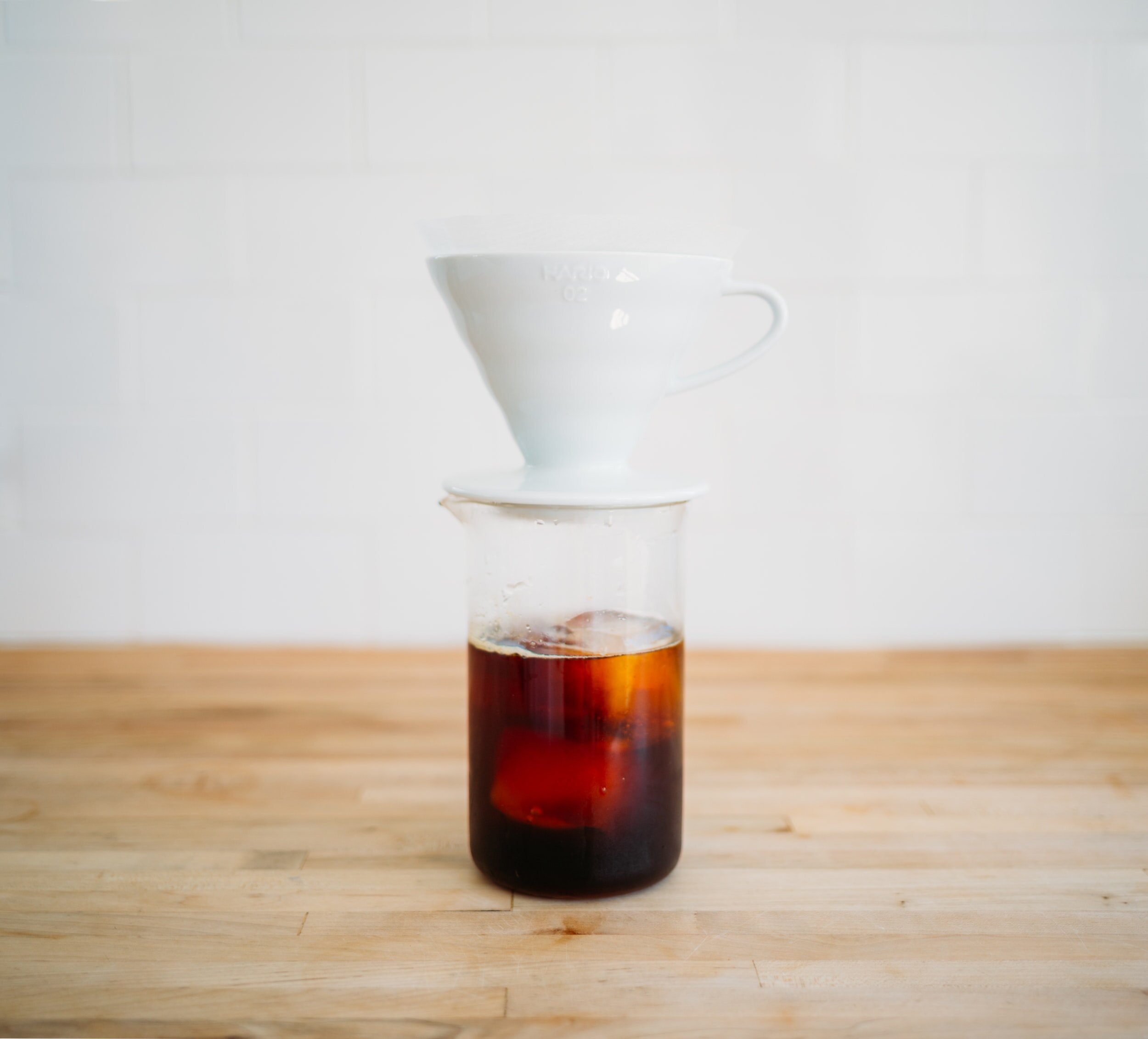 coffee dripper over cup of iced coffee
