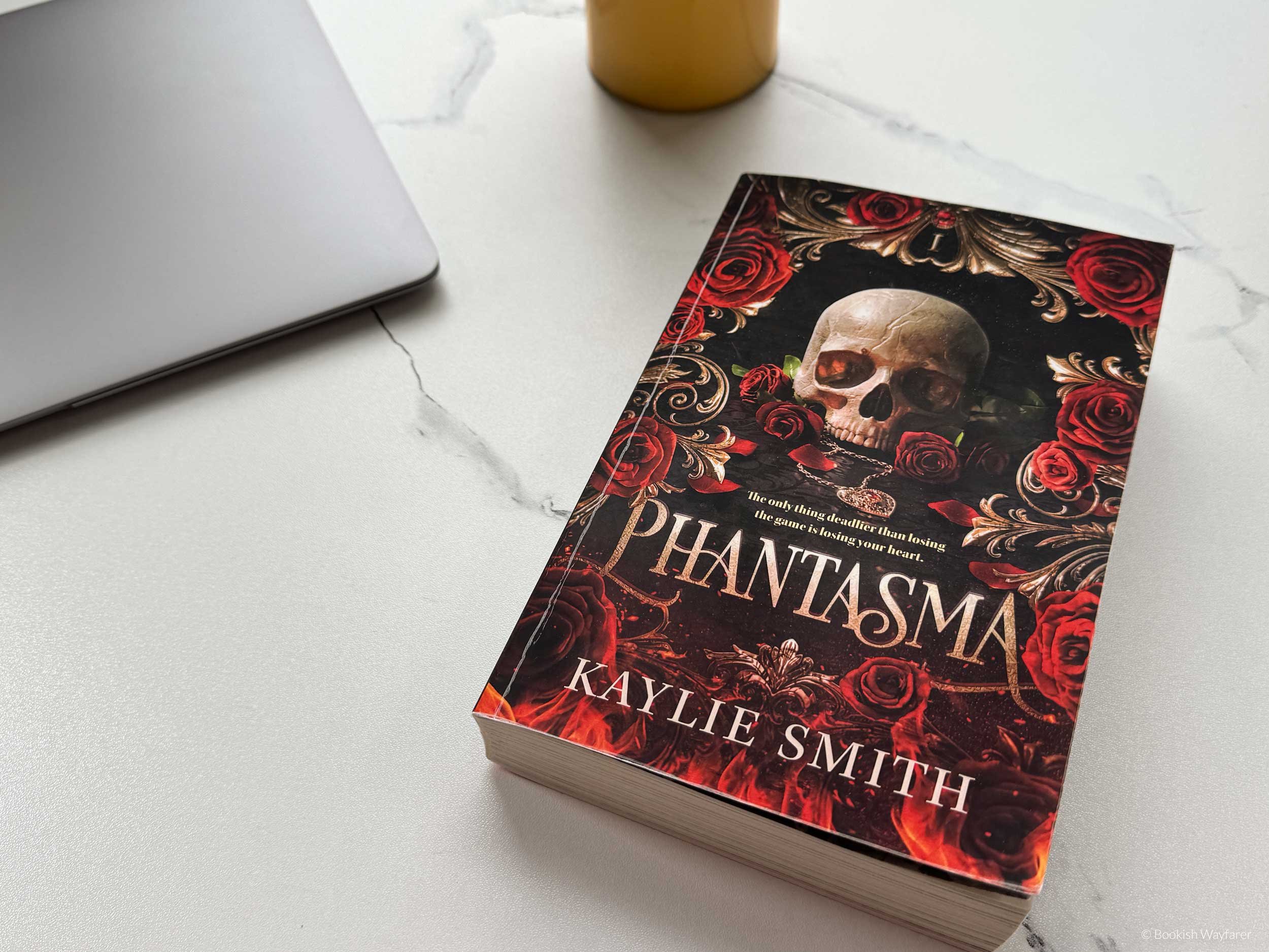 The book Phantasma laid flat atop a white table.