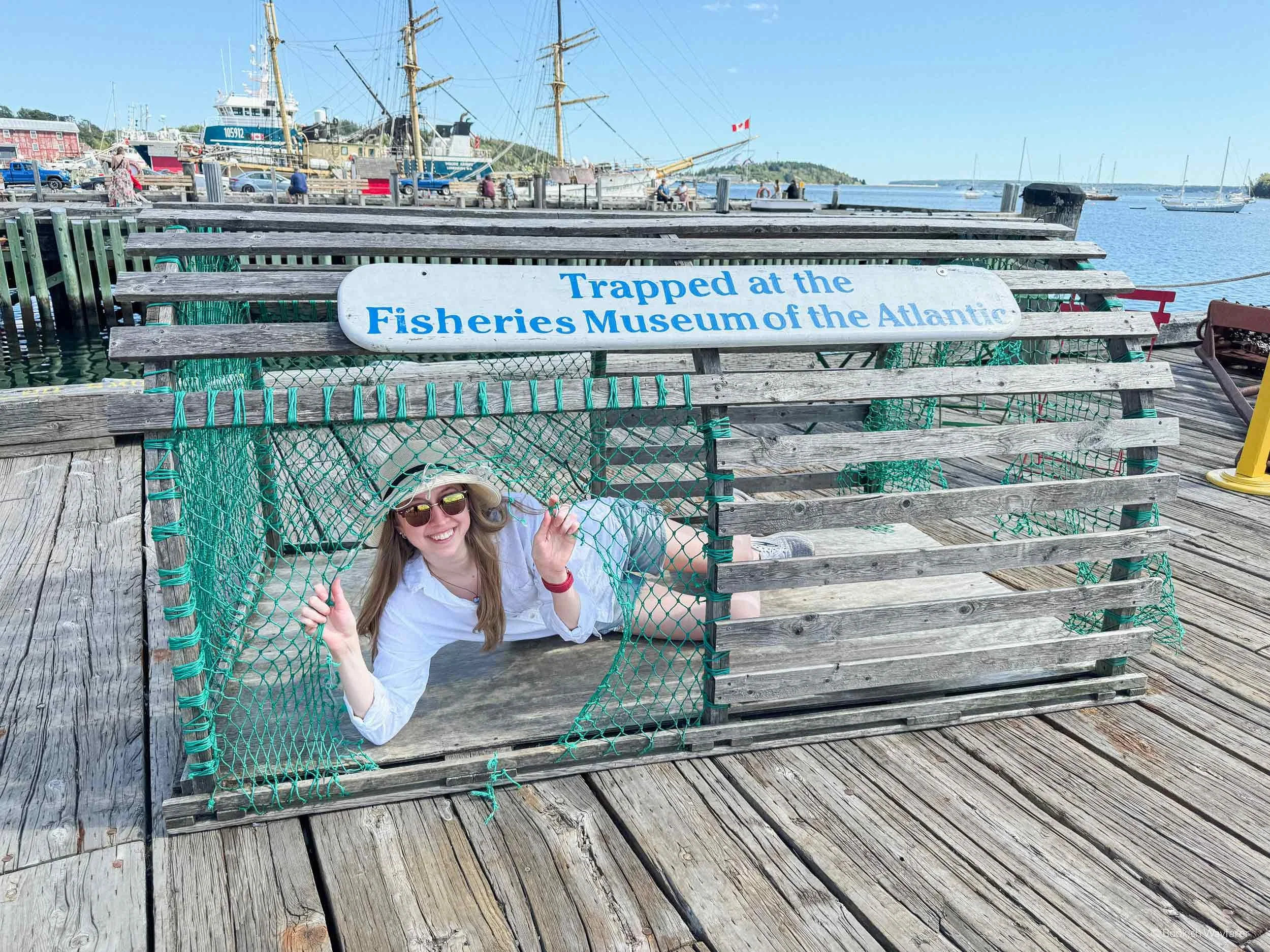 The author, Julia, poses inside a large lobster trap