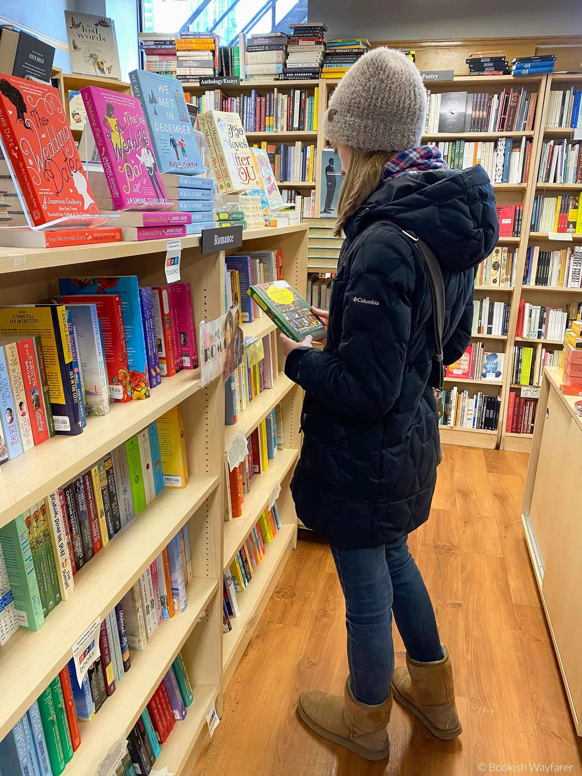 Author of blog post, a woman, holding up a book in Trident Booksellers