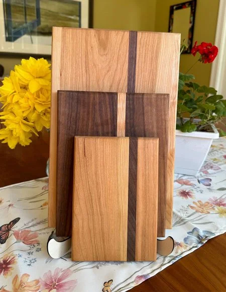Three wooden cutting boards stood upright