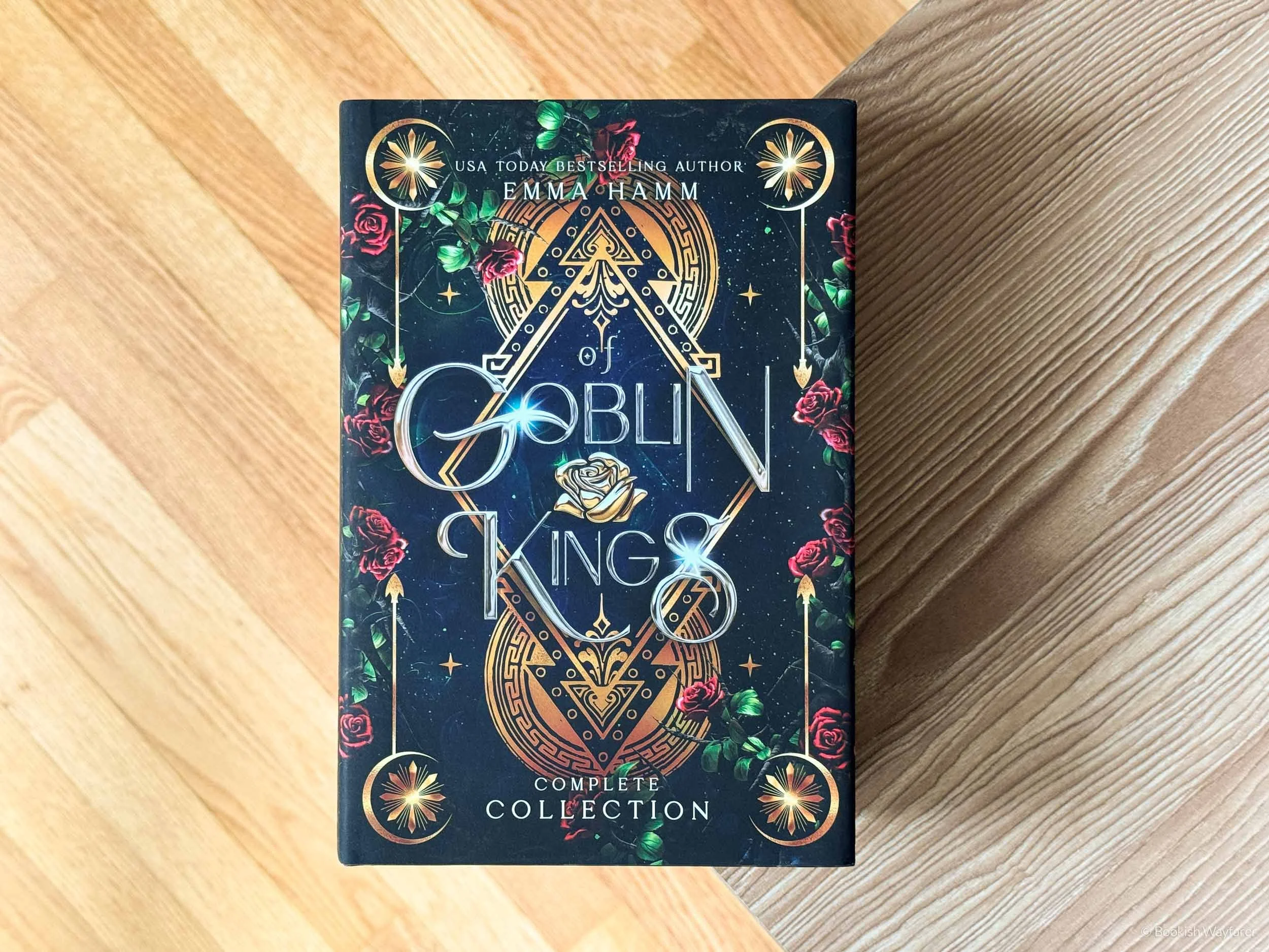 The book Of Goblins and Gold laid flat atop a wooden table