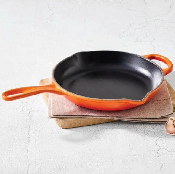 Orange Le Creuset cast iron skillet