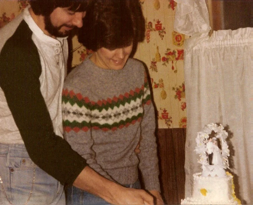 A couple cuts their wedding cake