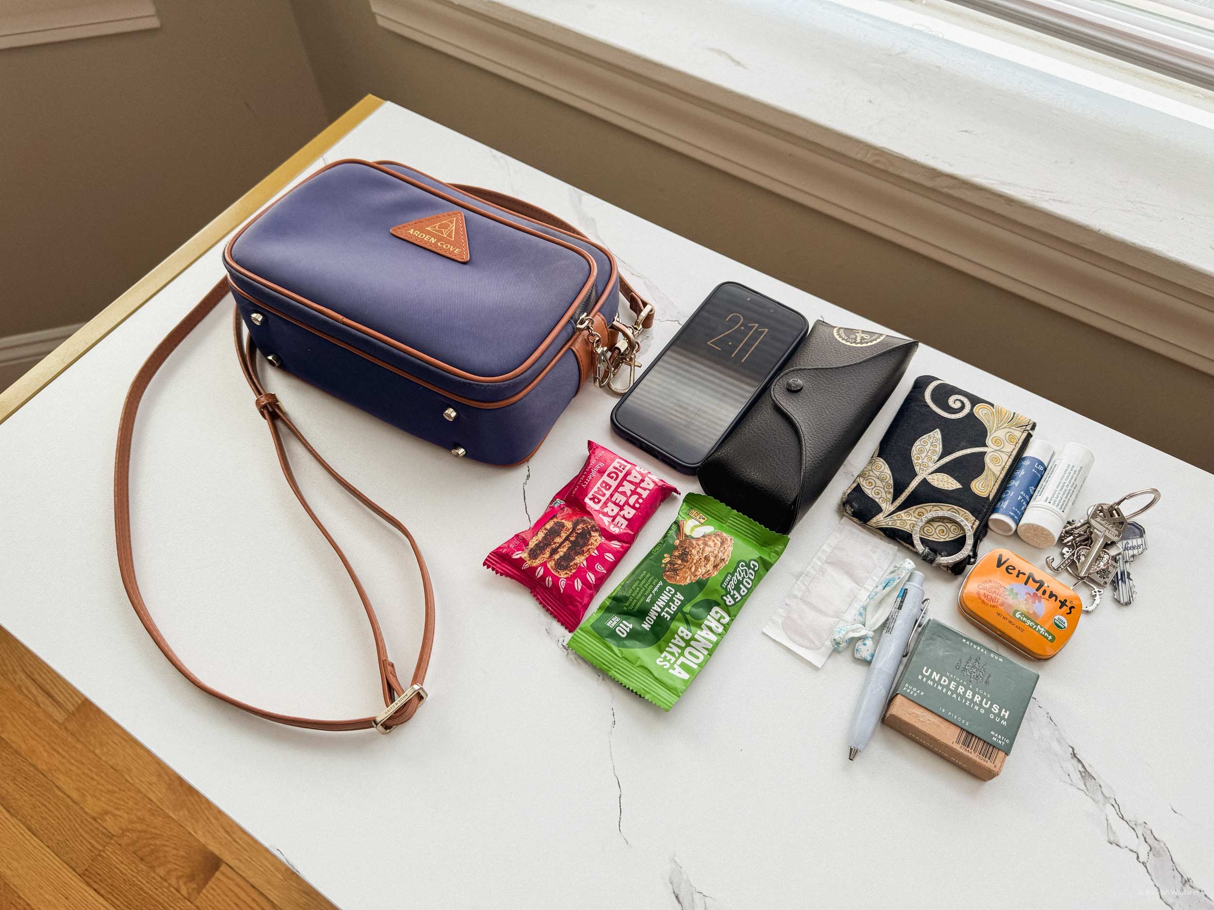 The Arden Cove Crissy Full Crossbody with all of its contents beside it