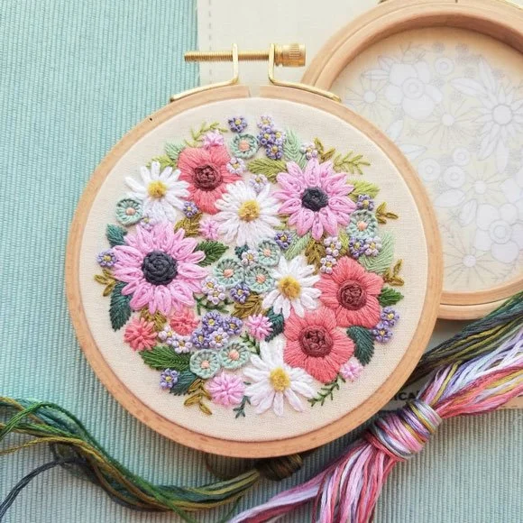 Embroidered flowers on linen finished with a wooden hoop