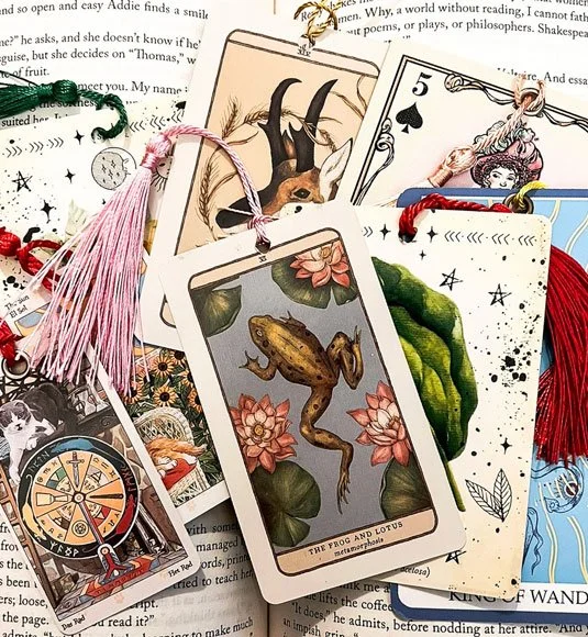 Tarot card bookmarks piled atop an open book