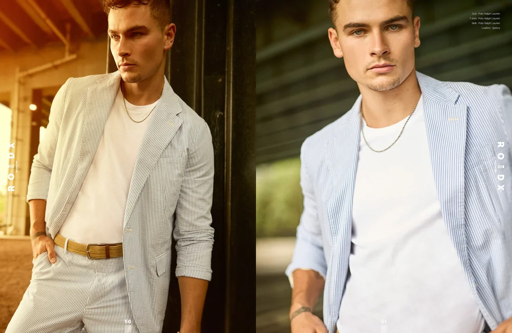 Man wearing light striped suit with white shirt and chain, styled photoshoot, ROIDX magazine branding.
