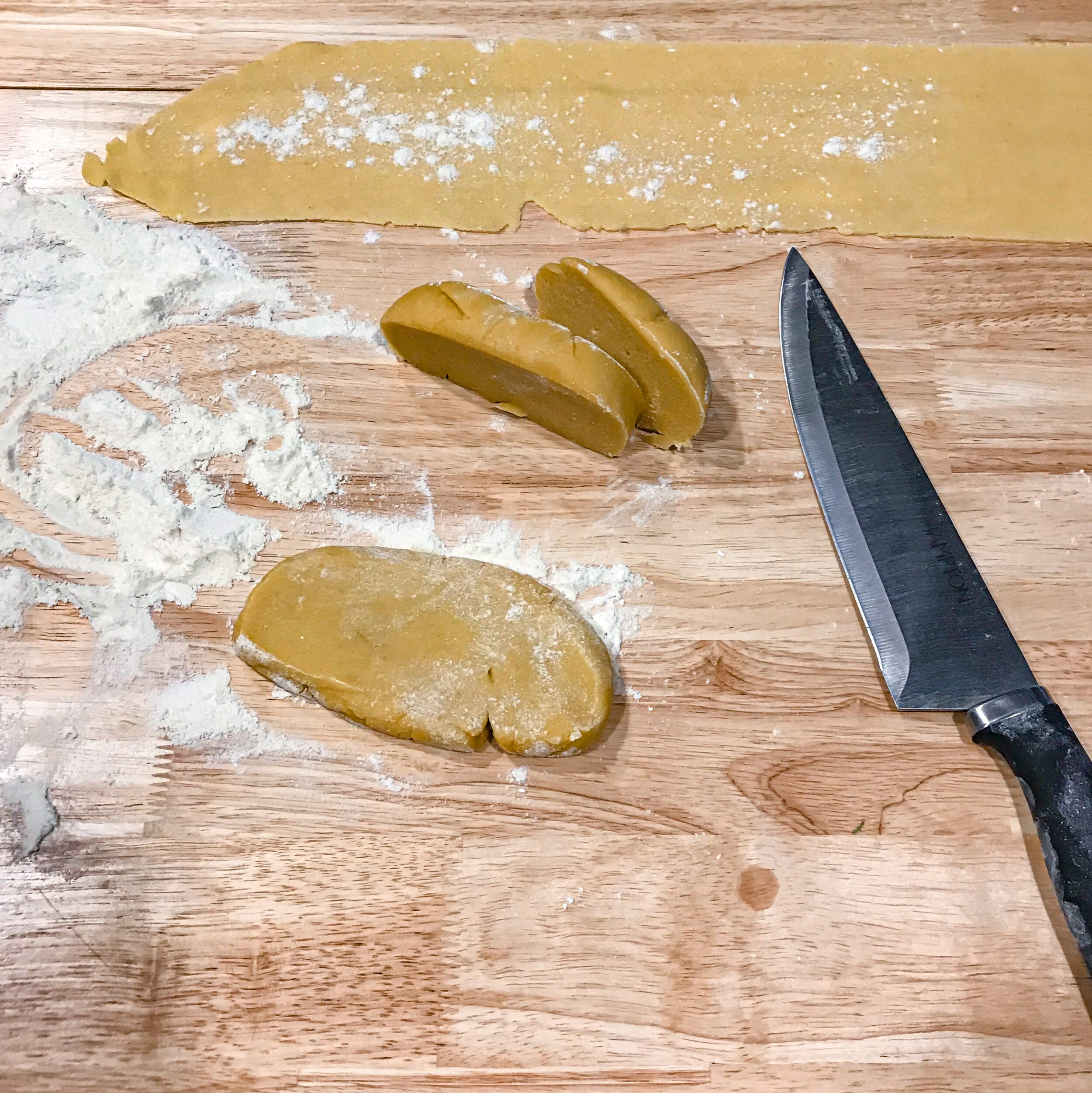 Slice your dough ball into equal sections and flatten into disks.