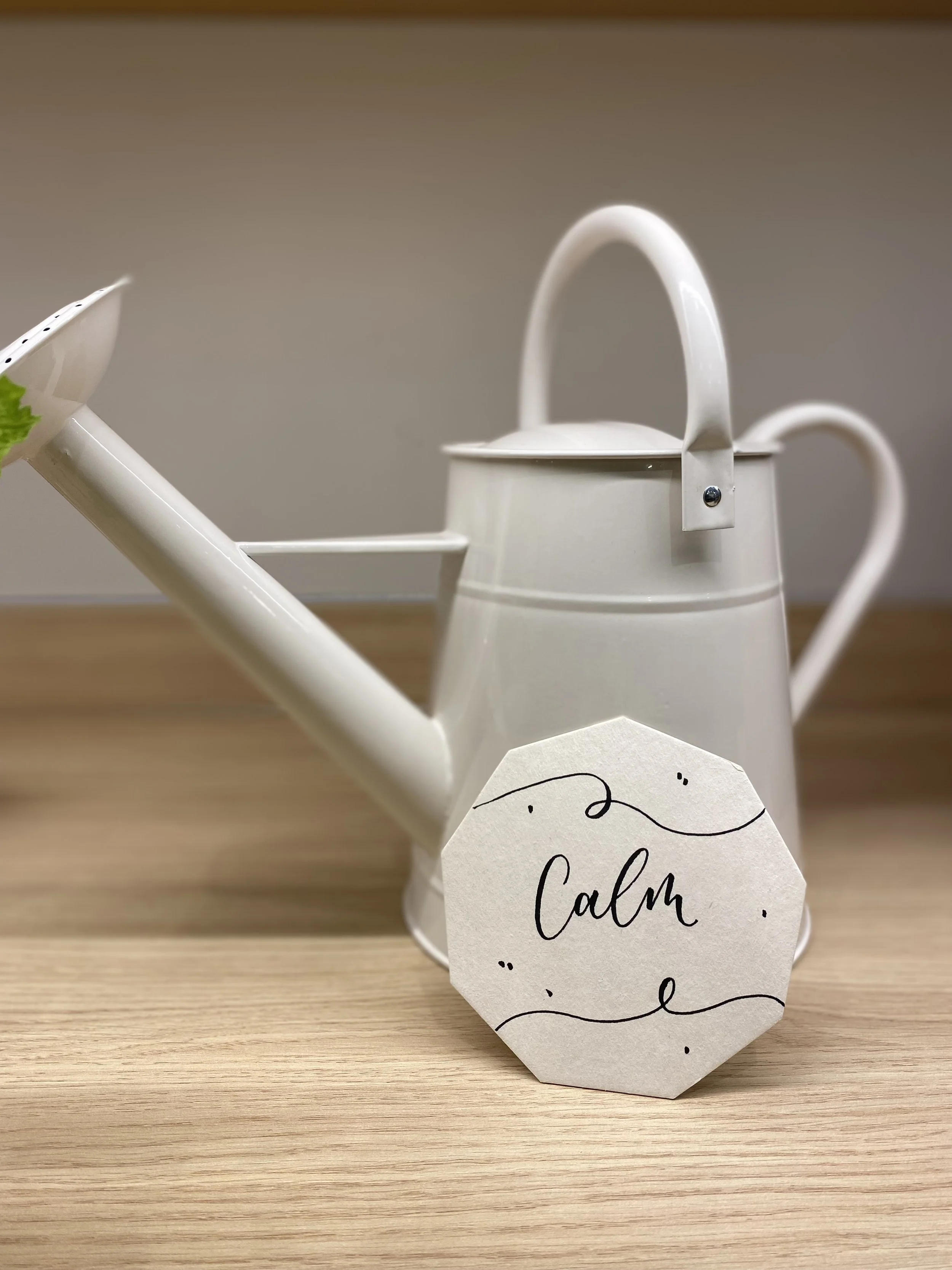 'Calm' in brush pen calligraphy on a coaster