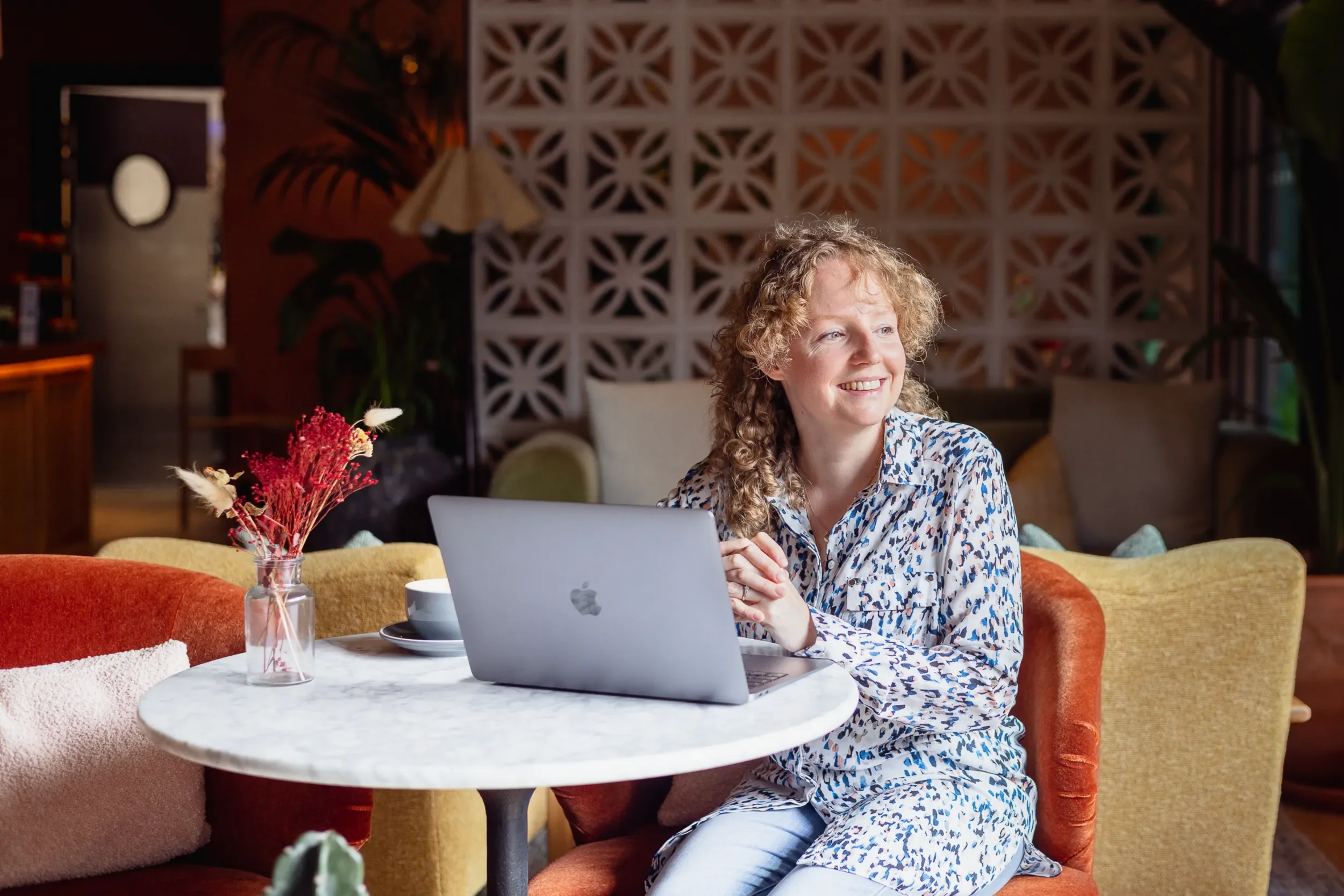 Laura Edralin Podcast Host Sitting At Laptop With Inspiration