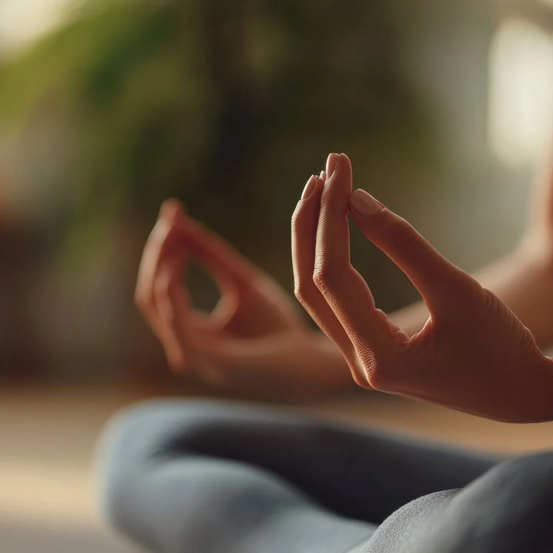 Close-up of a hand in a meditation mudra gesture, representing the mindfulness practices used at Drishti Holistic Wellness