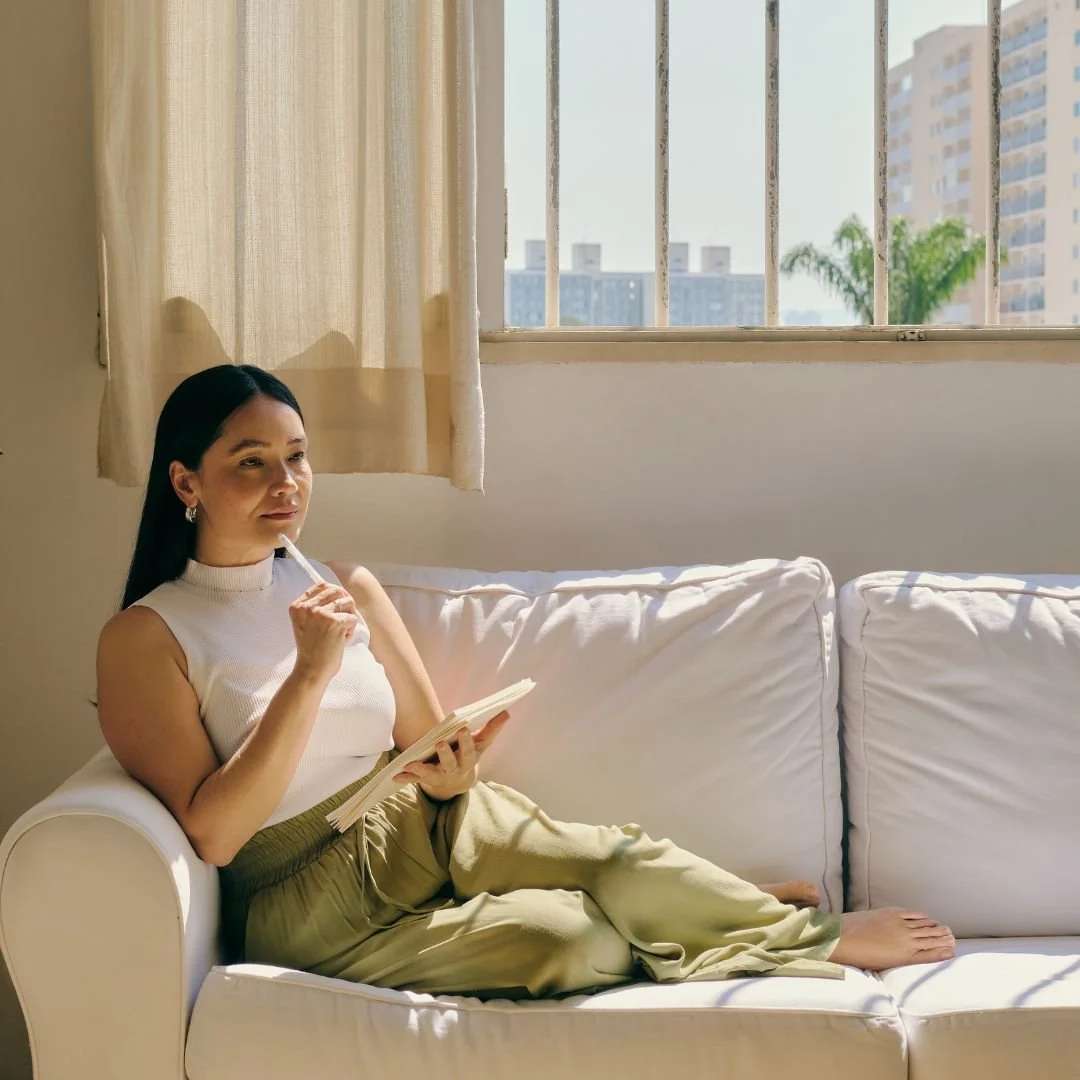 Woman practicing mindfulness and journaling at home, reflecting the calm, reflective approach to care at Drishti Holistic Wellness