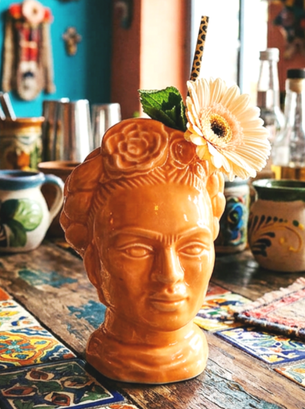 Hand made ceramic Frida tiki mug glazed in a vibrant orange side view