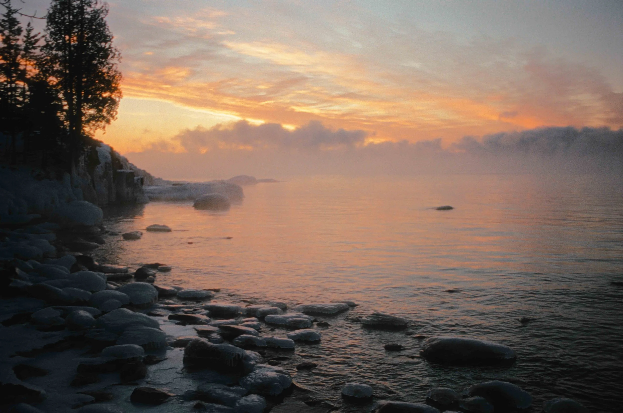 Dramatic Winter sea smoke sunrise at Split Rock Lighthouse on Lake Superior, Minnesota
