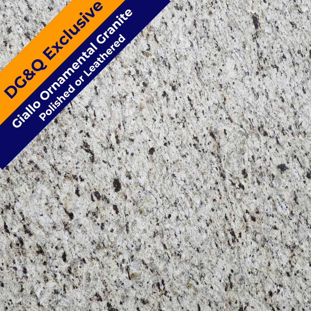 Close-up of polished Giallo ornamental granite with a light background and dark speckles