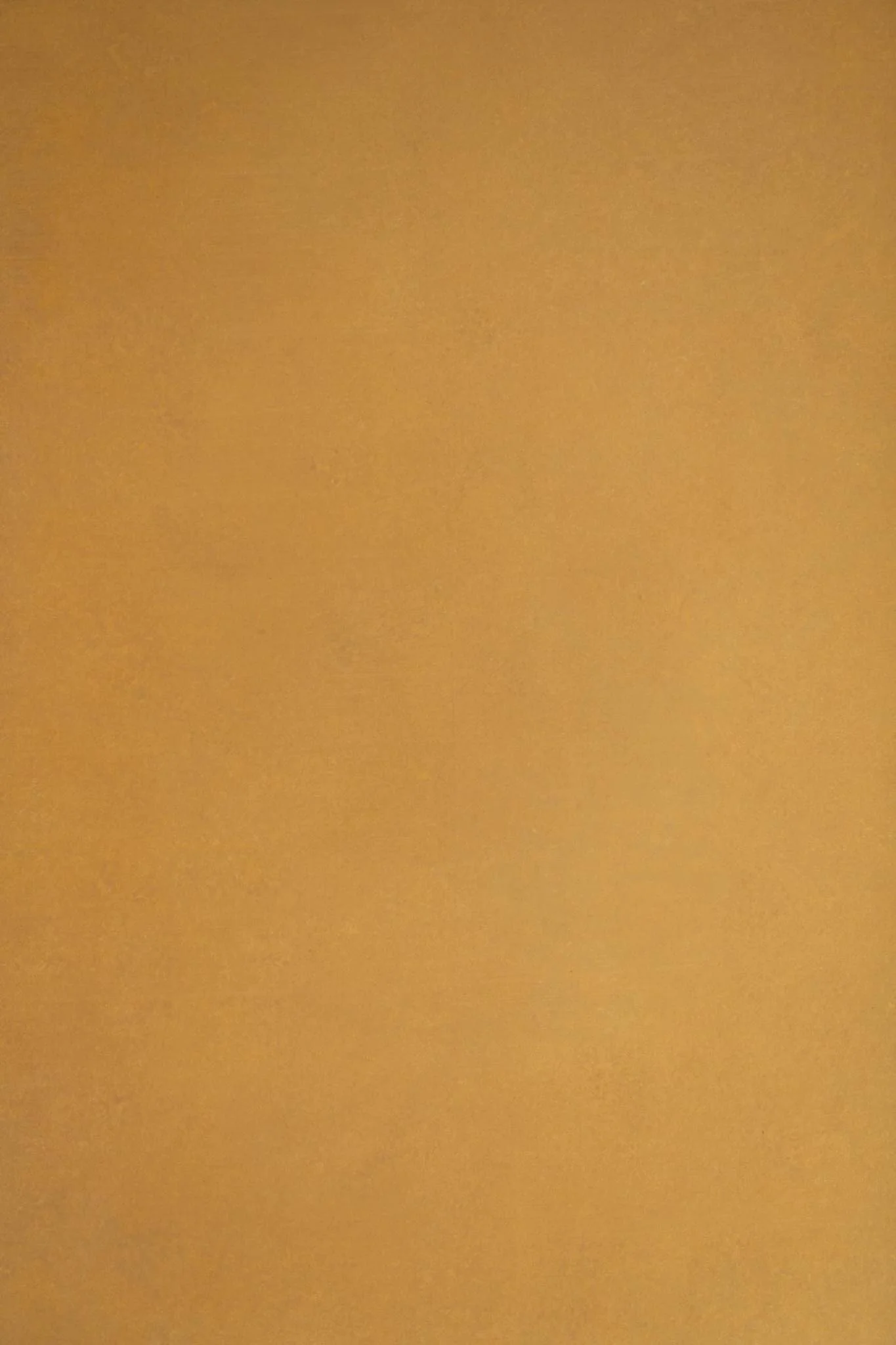 A close-up photograph of a yellowish-orange textured surface, possibly a wall or a piece of paper.