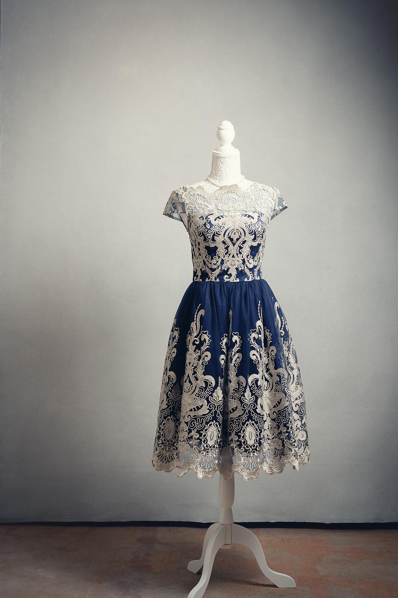 A vintage dress displayed on a mannequin with a plain background.