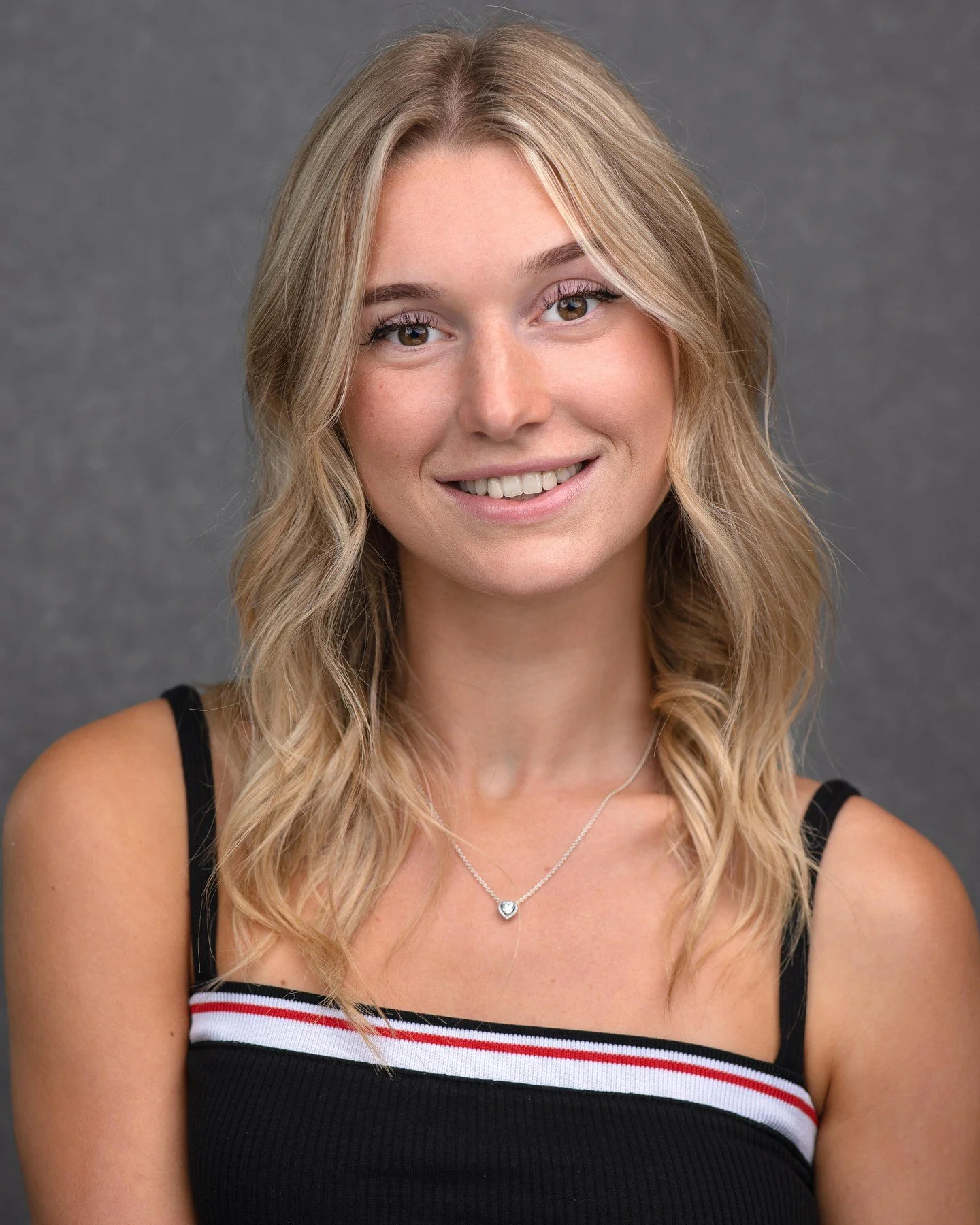 That soft diffused lighting positioned slightly above and to the side is creating these deliciously gentle shadows that sculpt her features without going all moody mystery novel on us - watch how it illuminates her skin with that natural glow while h