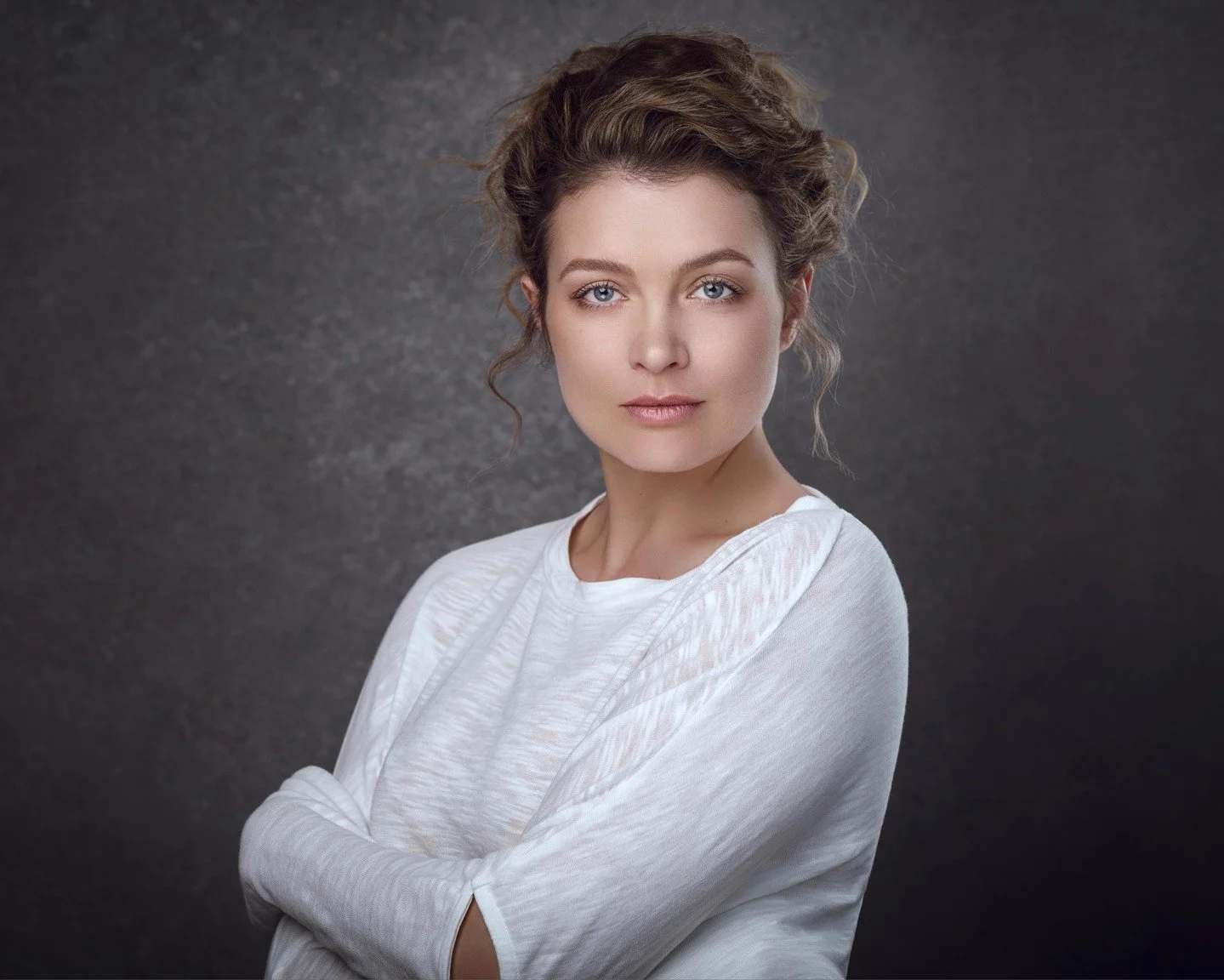 That soft even lighting from what looks like a large softbox is wrapping around her face with such buttery smoothness creating those barely-there shadows that flatter without going flat - watch how it illuminates her features and highlights without h