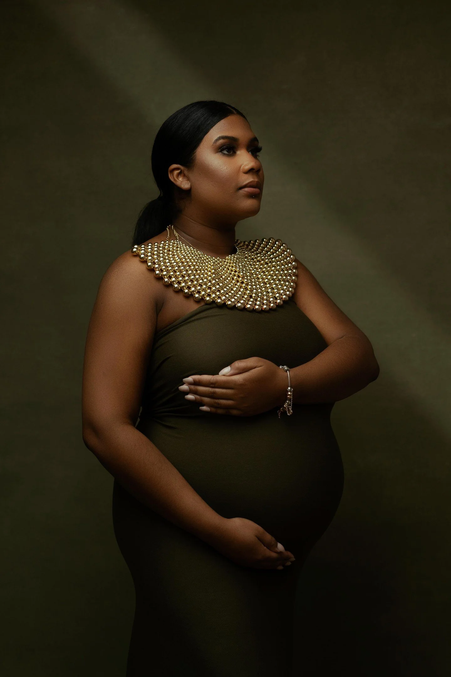 That gentle spotlight is absolutely doing the heavy lifting here creating these stunning dimensional shadows that sculpt her profile like a Renaissance painting while her face catches that perfect rim of light that makes her features pop against thos