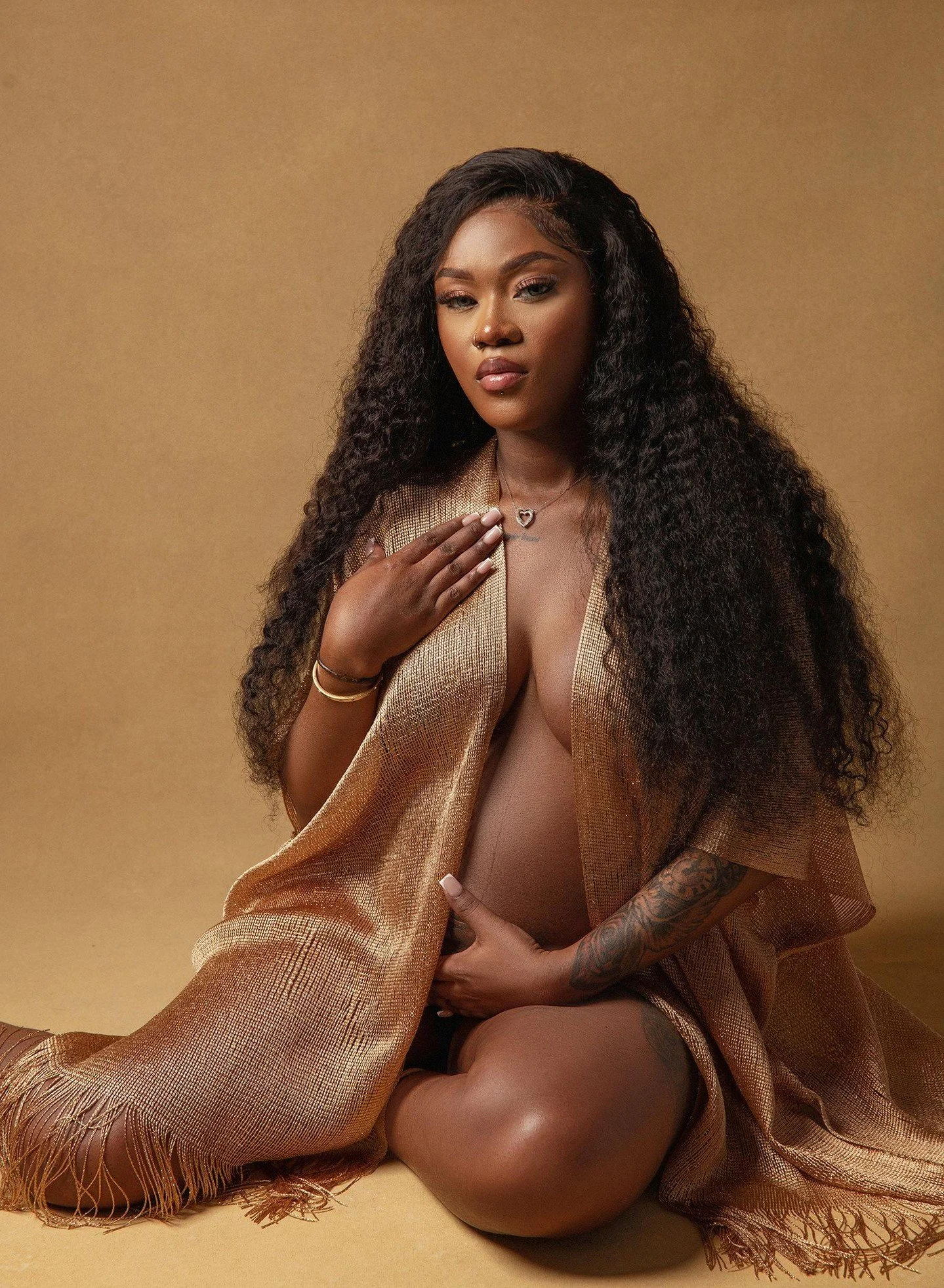 That soft diffused lighting is absolutely wrapping this whole scene in buttery warmth that makes the earthy toned hand-painted backdrop and her golden shawl have a full conversation about complementary color theory without saying a single word, and c