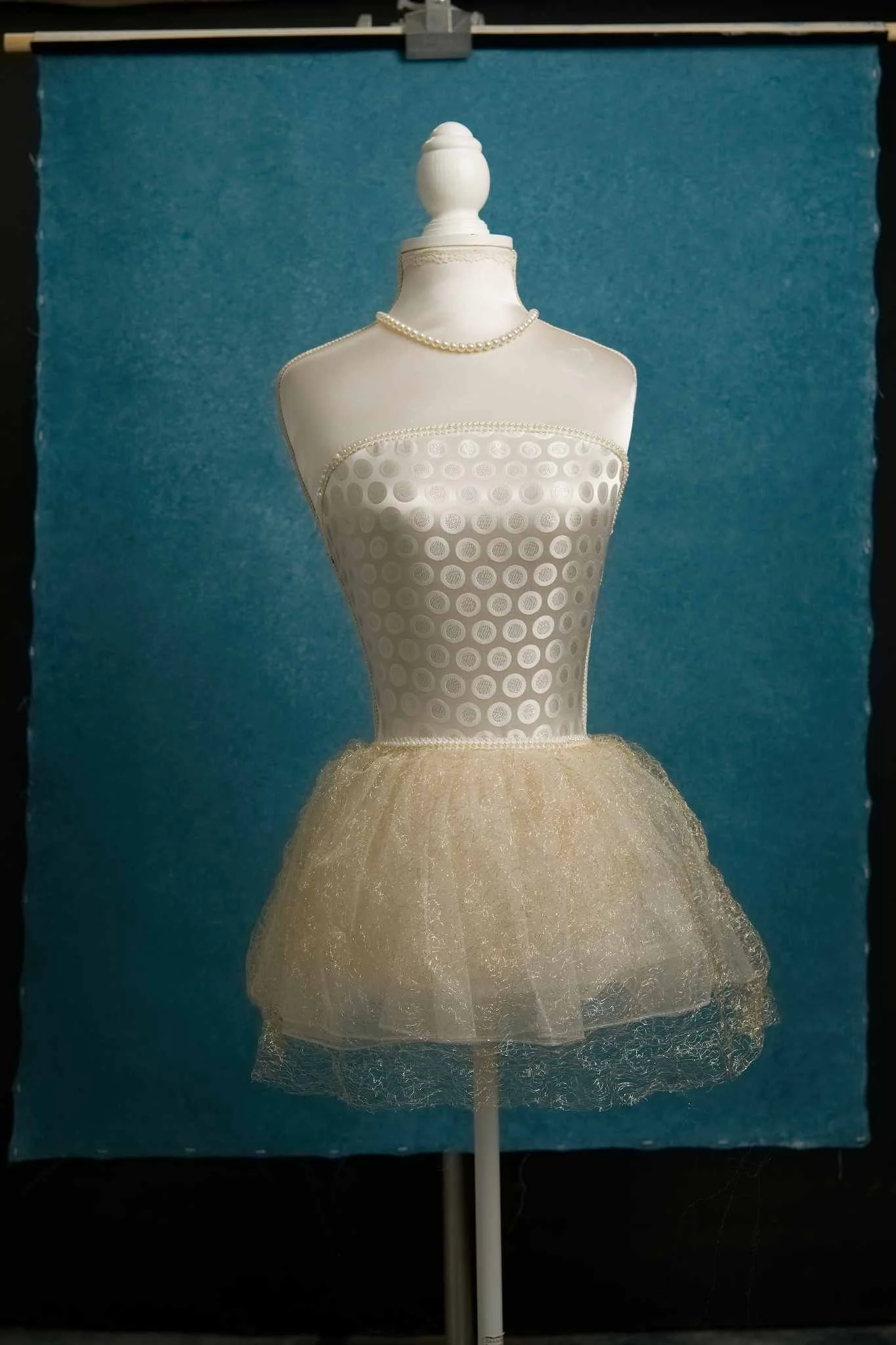 Mannequin with gold tulle skirt on teal hand painted canvas backdrop 100x135cm UK