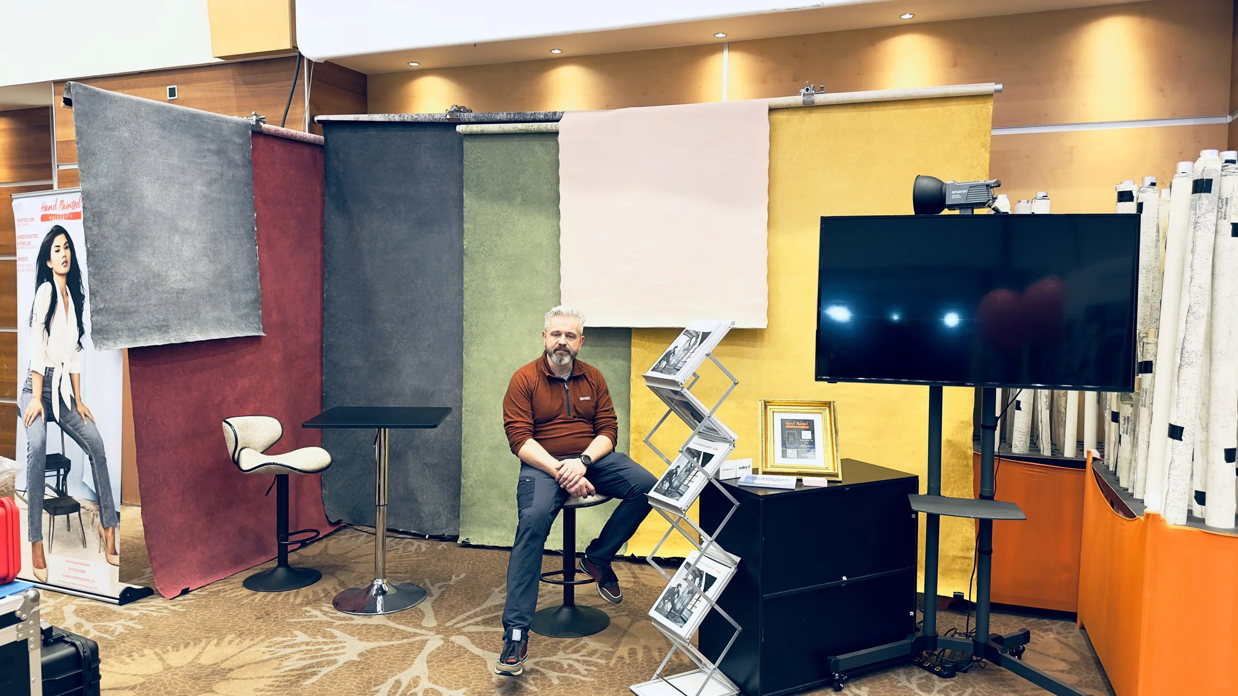 Hand Painted Backdrops UK exhibition stand at the SWPP Trade Show, displaying colourful canvas photography backdrops.