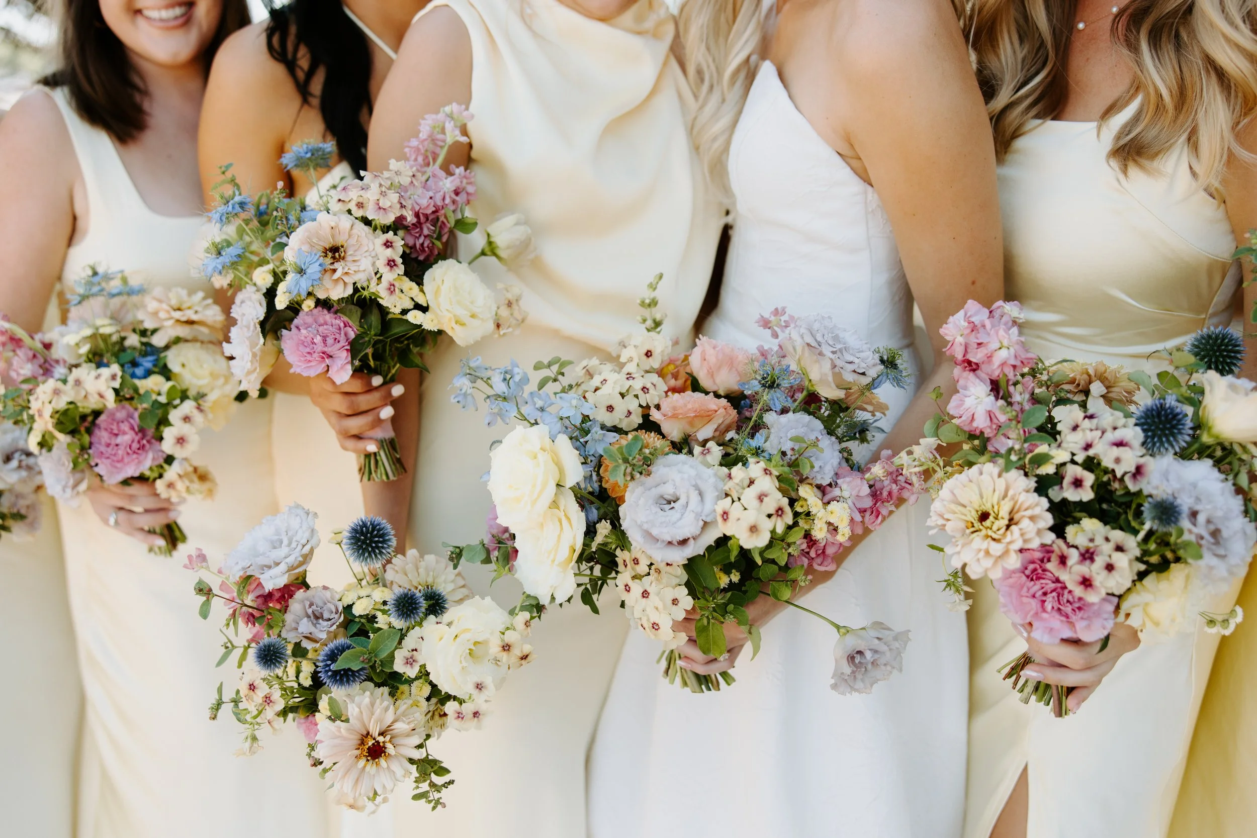colorful spring pastel bridal bouquets & bridesmaids with yellow silk dress, wedding at The Essence in St. Paul MN
