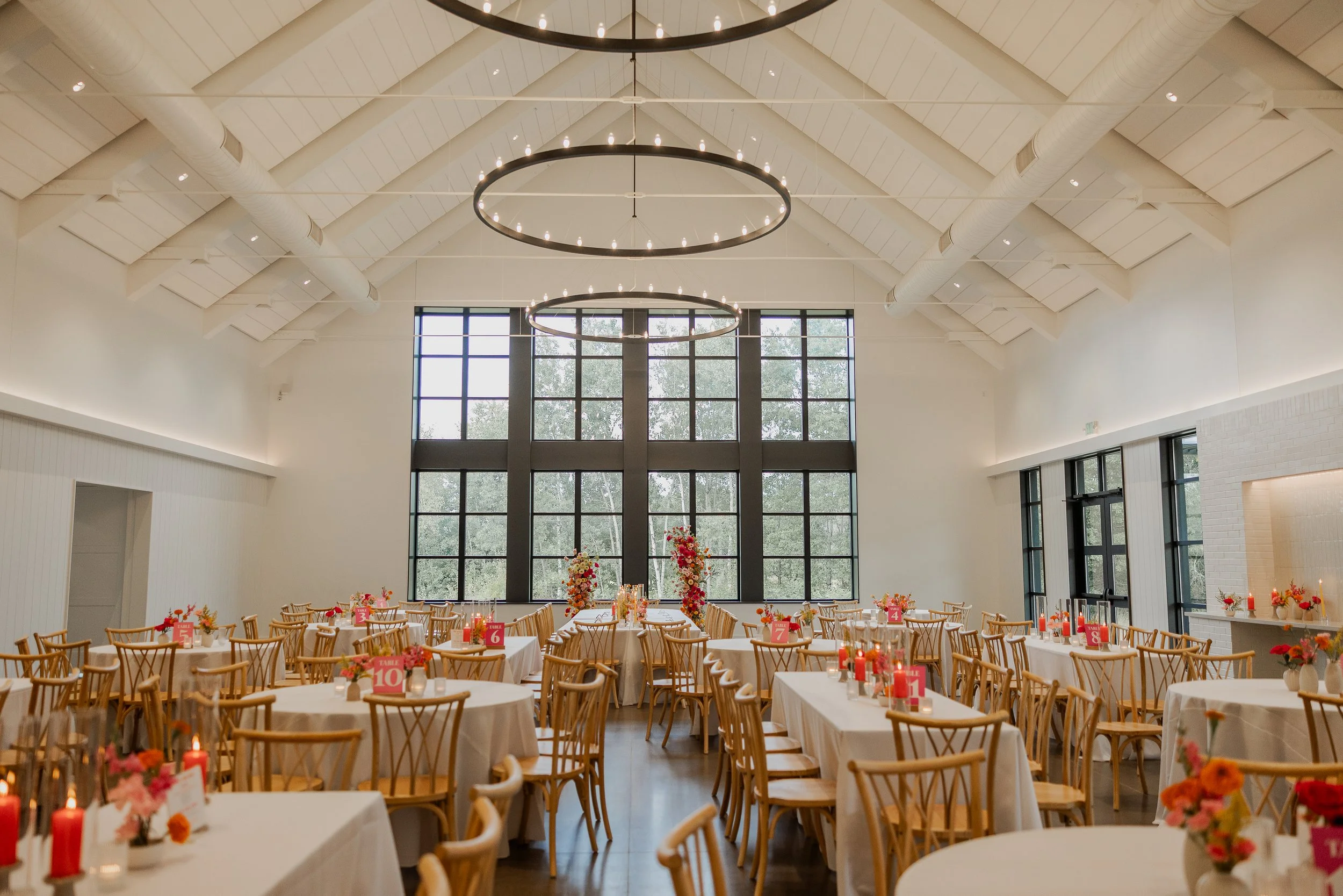 dinner/reception room shot with bright + colorful flowers and candles, White & Sable wedding in Ham Lake MN