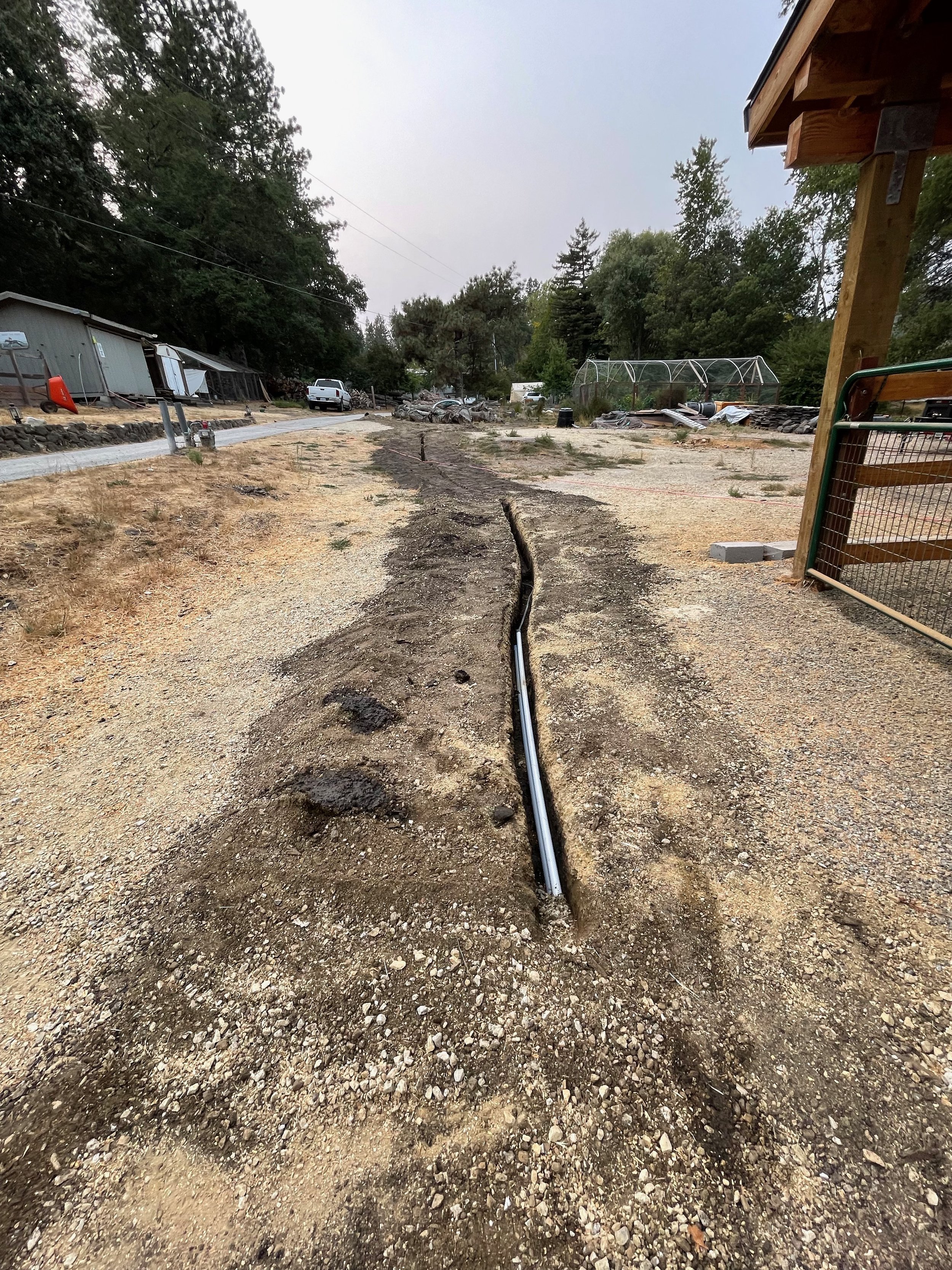 Covering up the trench as we get the conduit and pipe laid to the sources