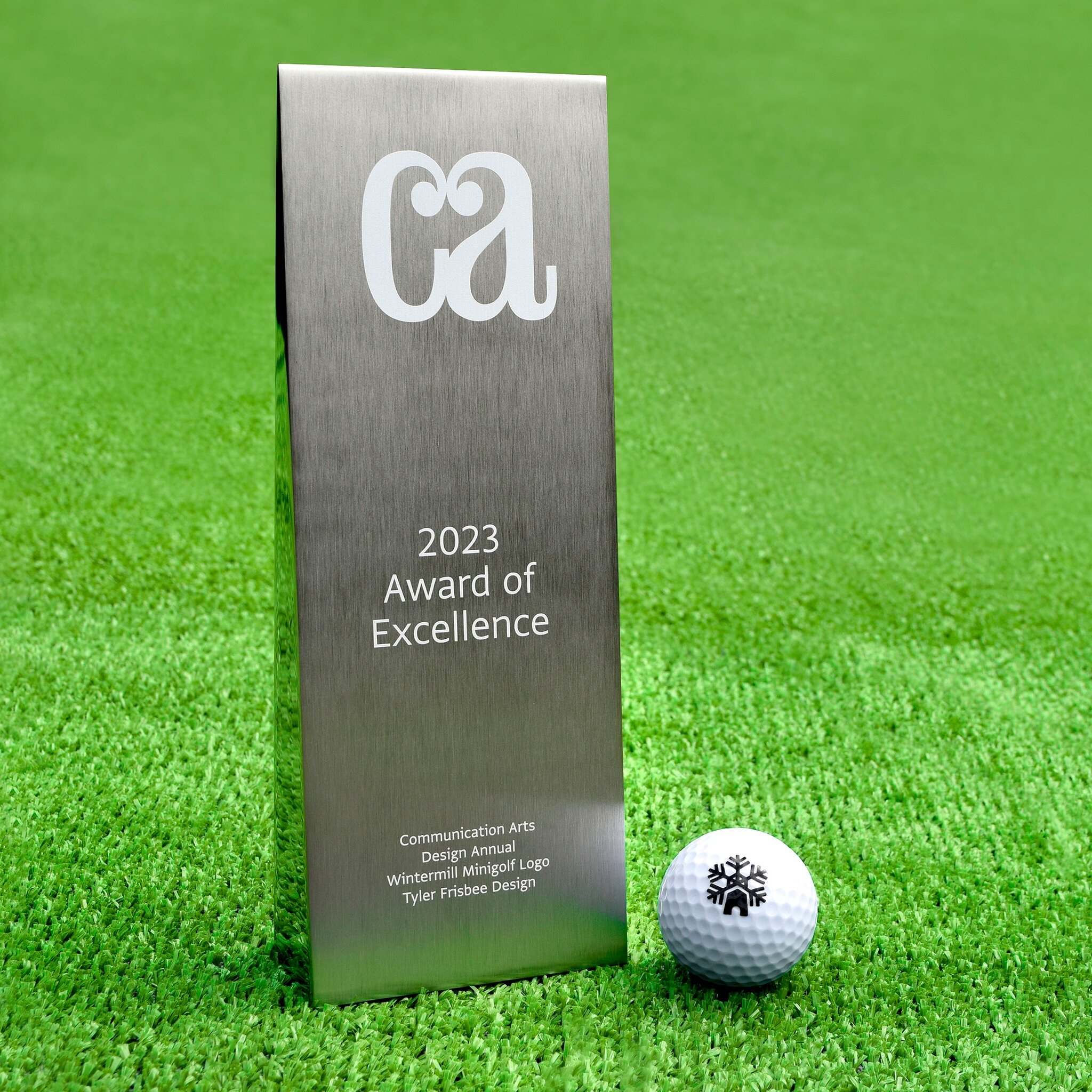 HOLE IN ONE! 🏌️ Just got this bad boy in the mail with a copy of the 2023 Design Annual (second slide). Pretty validating, as far as slabs of metal go. I&rsquo;m shocked I was able to make CommArts this year&mdash;and with a logo at that. Thanks for