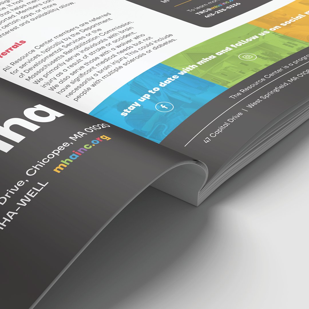 magazine closeup with social media links and colorful url