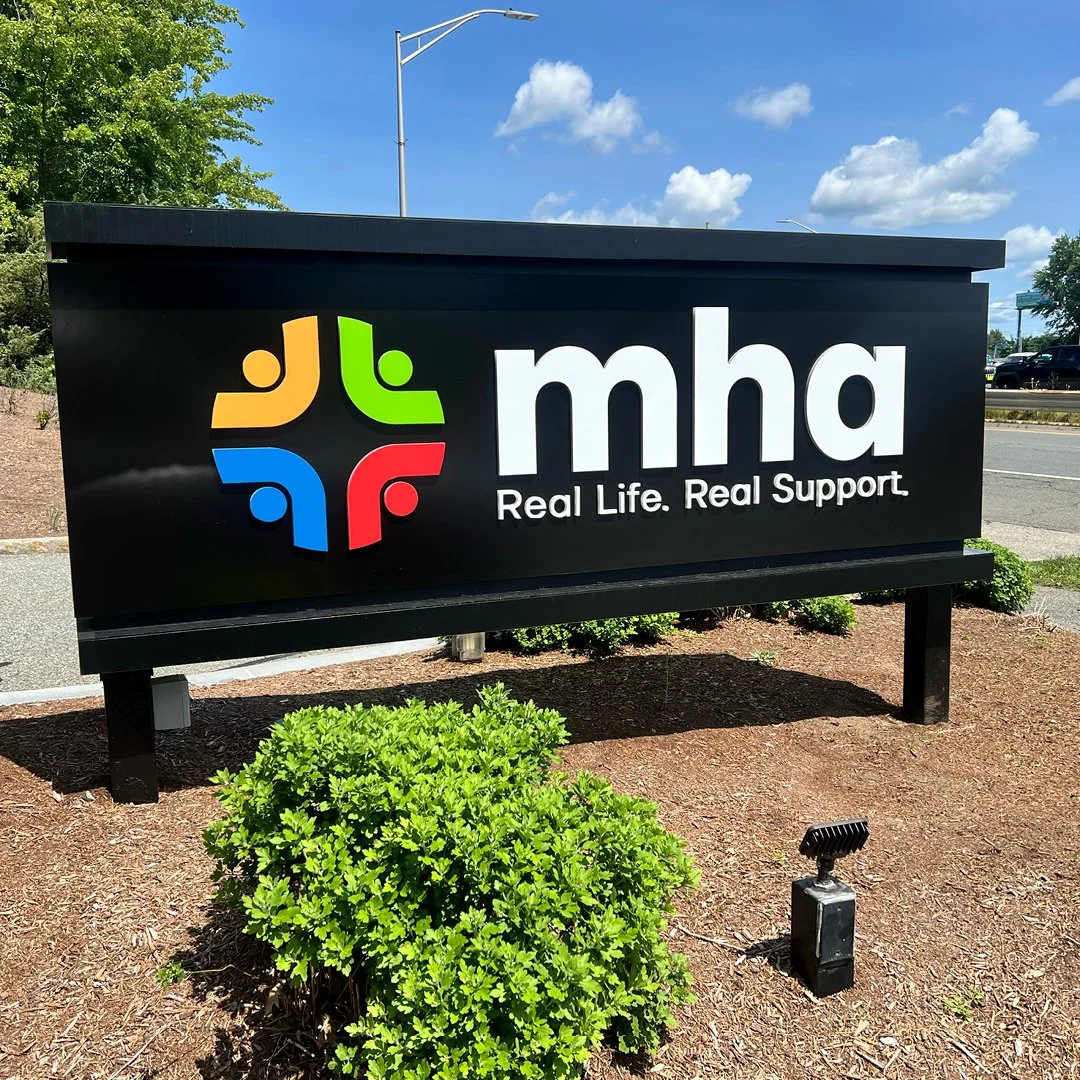 building exterior signage, black marble with white lettering and multicolor logo