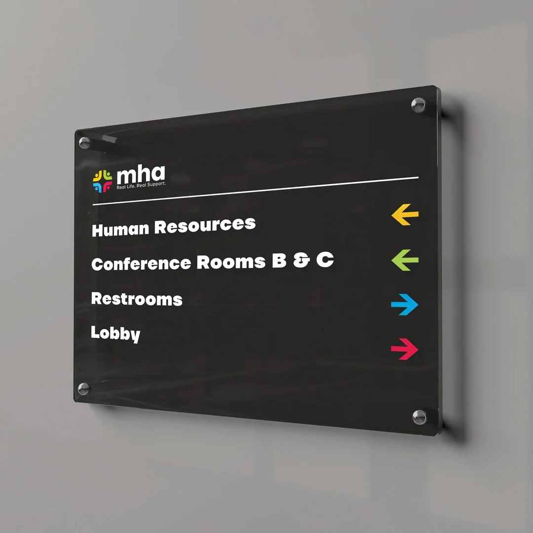 Wayfinding acycrlic signage, colorful arrows on black glass