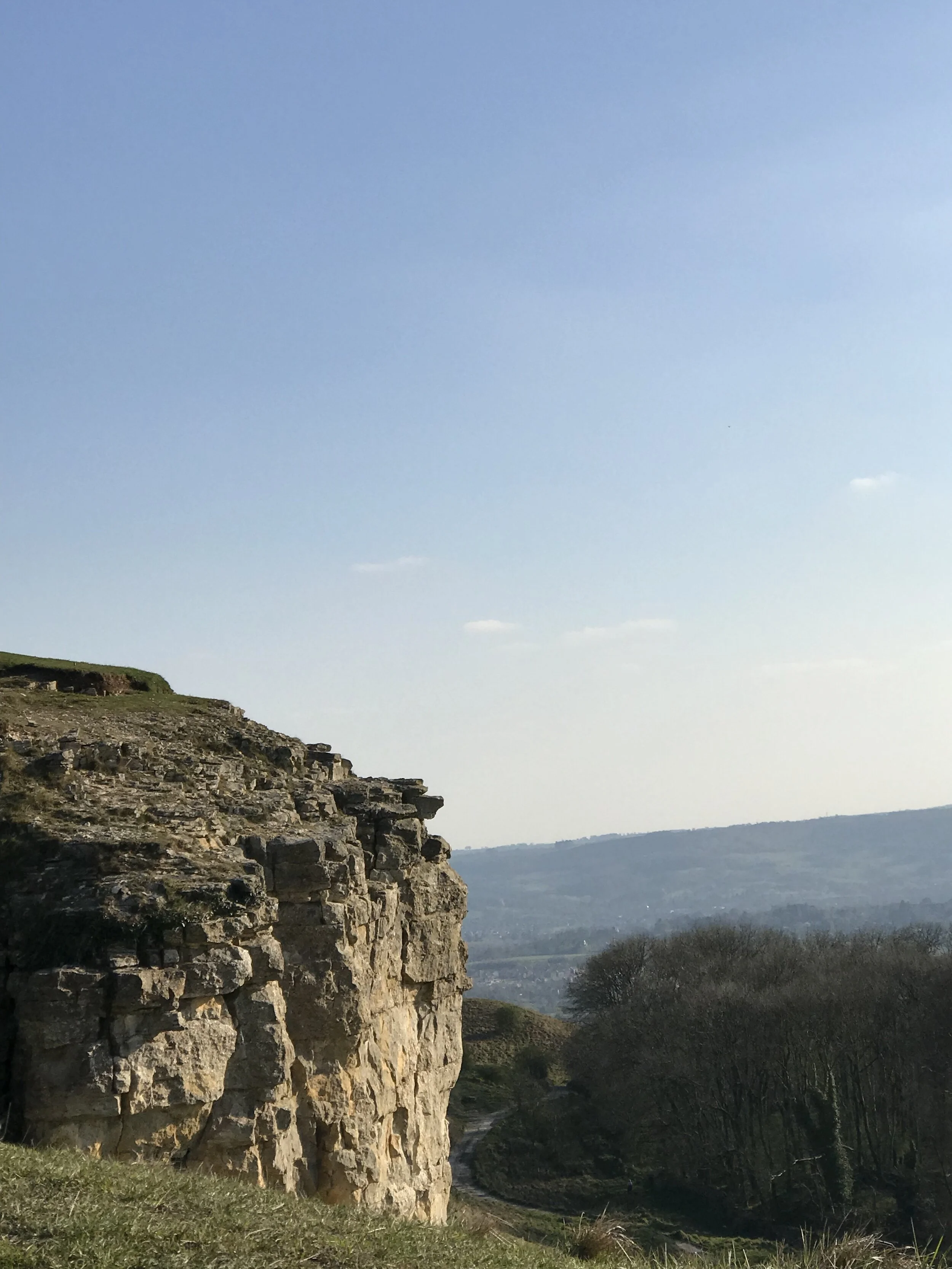Cleeve Cloud, Cleeve Hill standing at 1,083 feet (330m) at its trig point and with Leckhampton Hill in the far background, Cheltenham nestling in between the two. This is the Escarpment of the Cotswolds that gives spectacular views into England, nor…